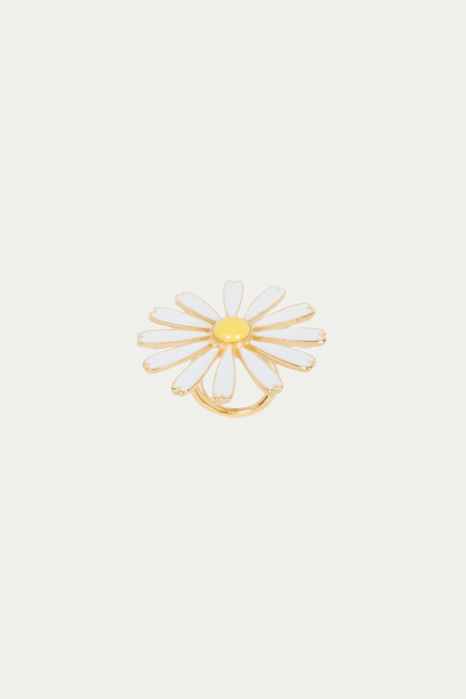 The TT x KJL Daisy Enamel Ring features white enamel petals and a yellow center in a daisy design, presented on a plain white background.