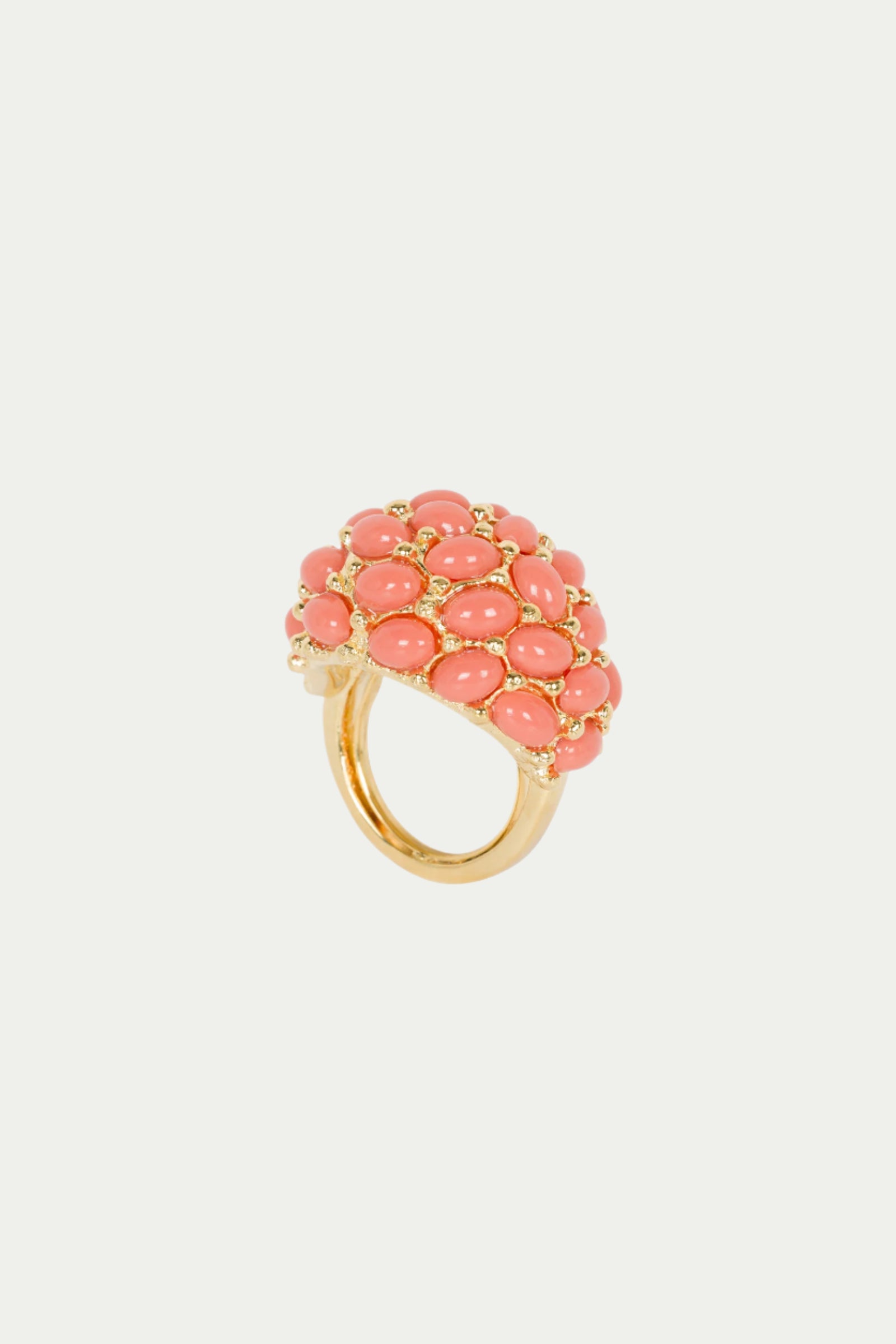 The TT x KJL Cabochon Adjustable Ring in coral features a dome-like cluster of oval cabochon stones set closely together, shown on a plain white background.