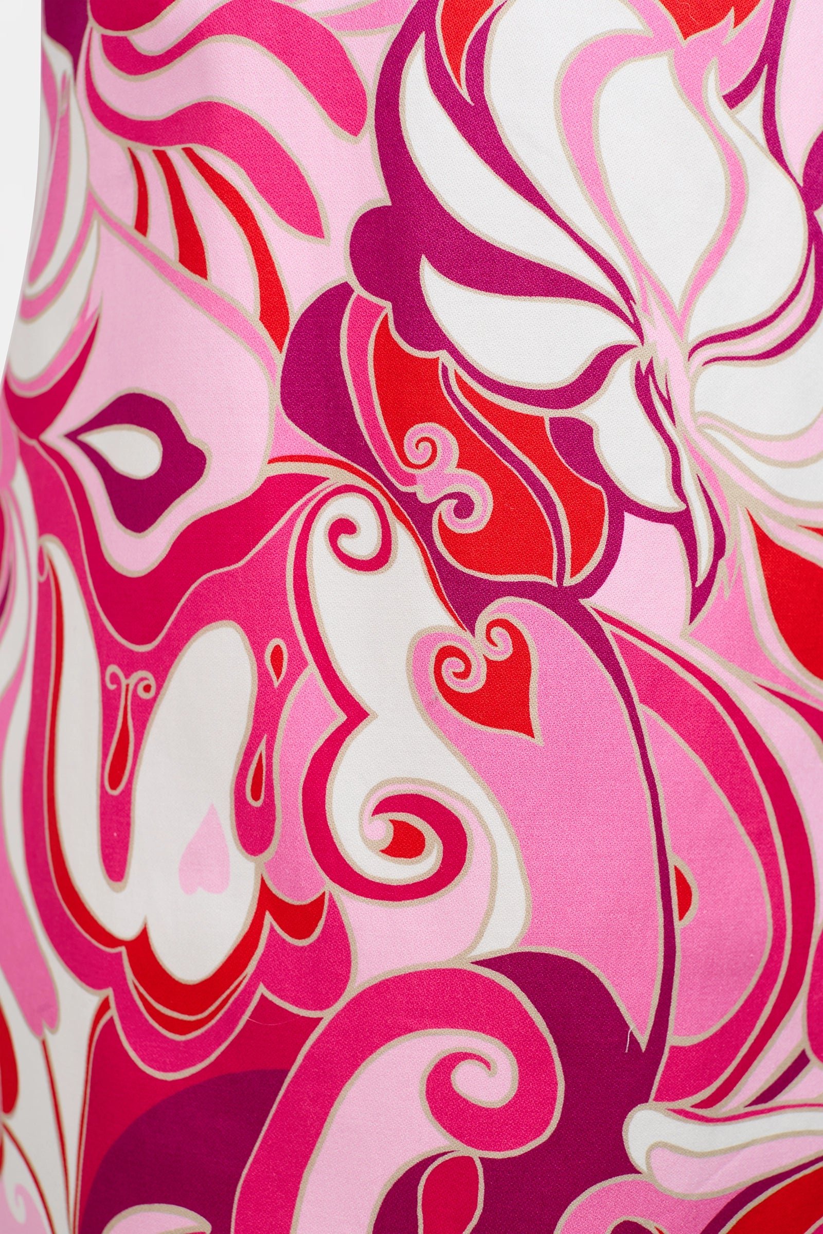 Close-up of the Cappuccia Lace-Up Mini Dress, showcasing a vibrant abstract fabric with swirling pink, red, magenta, and white shapes that evoke stylized butterflies and flowers.