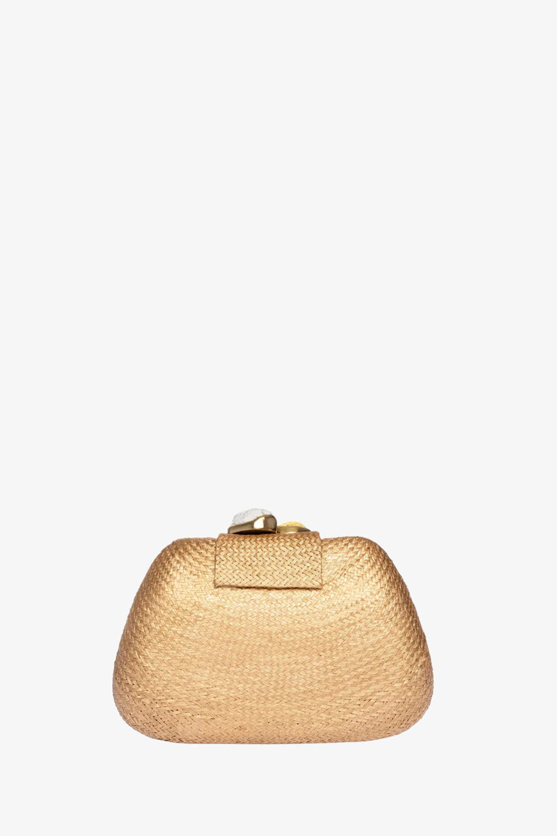 The Tamu Bean Clutch is a small, gold woven bag with a rounded shape and a rectangular flap closure, shown on a plain white background.