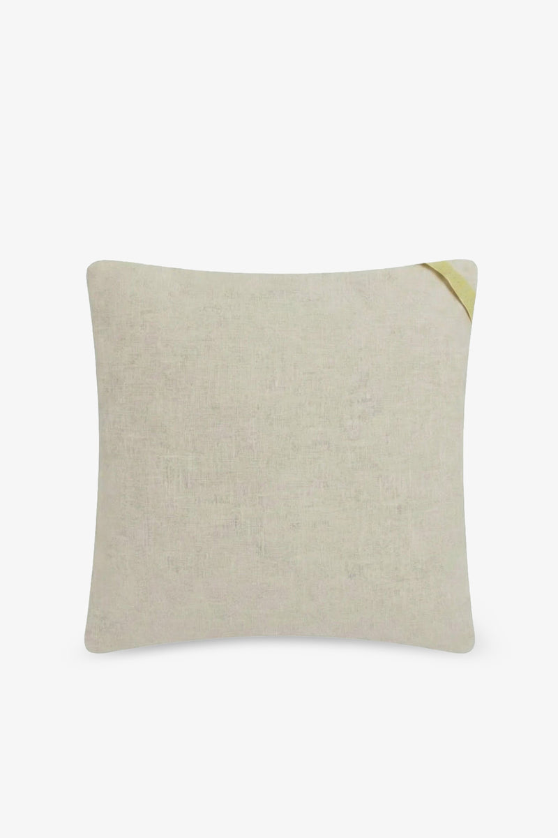 The Shante Embroidered Square Pillow is a rectangular, light beige pillow featuring a small yellow fabric accent on the top right corner, shown against a plain white background.