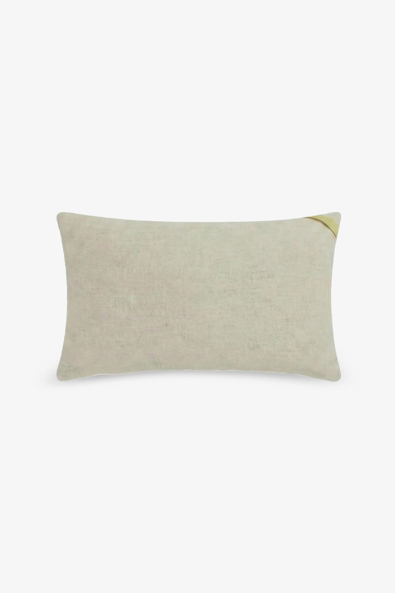 The Amazing Maze Embroidered Lumbar Pillow is a rectangular beige pillow featuring a subtle texture and a small, diagonal yellow accent on the top right corner, displayed against a plain white background.