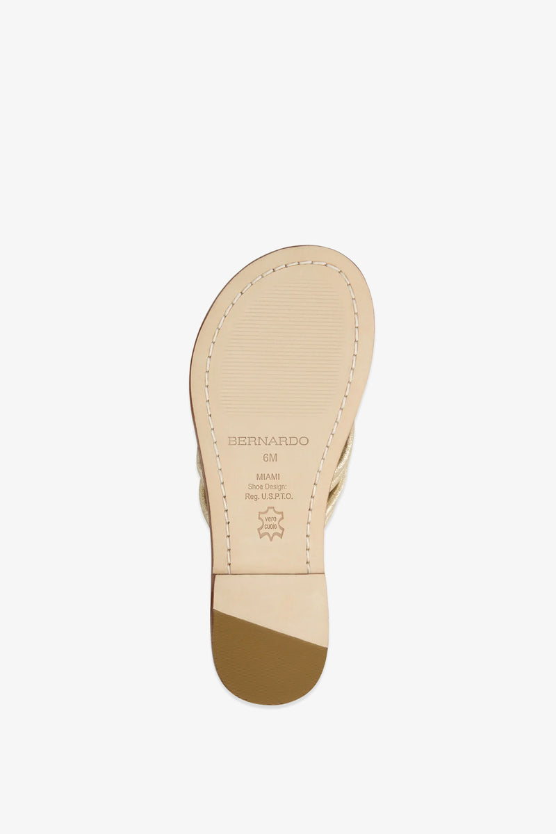 The sole of the Miami Sandal in beige features visible stitching, a small heel, and is stamped with the brand name Bernardo along with size and material information on the bottom.