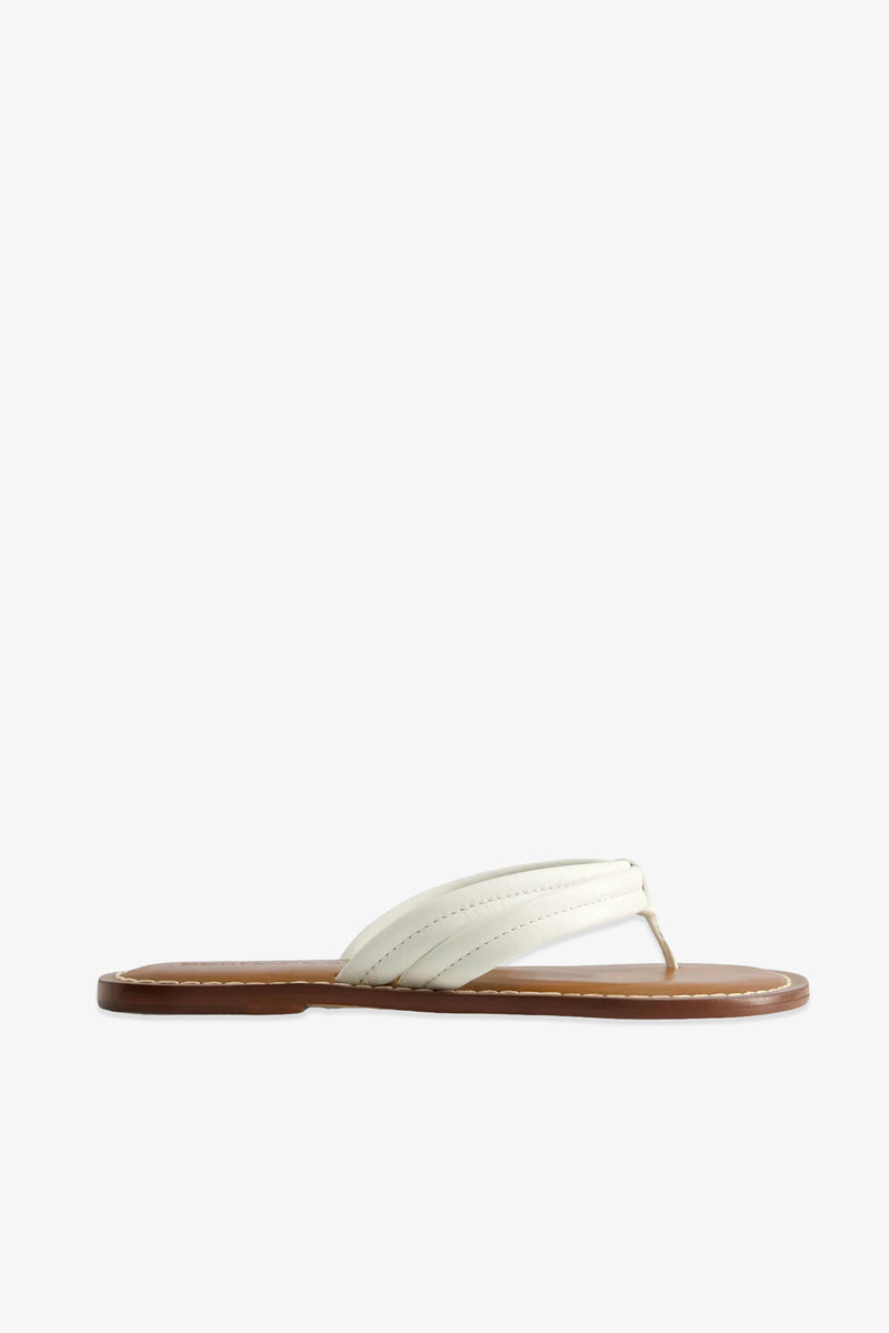 The Miami Sandal is a single white flip-flop featuring a padded strap and a flat brown sole, shown in a side view against a plain white background.