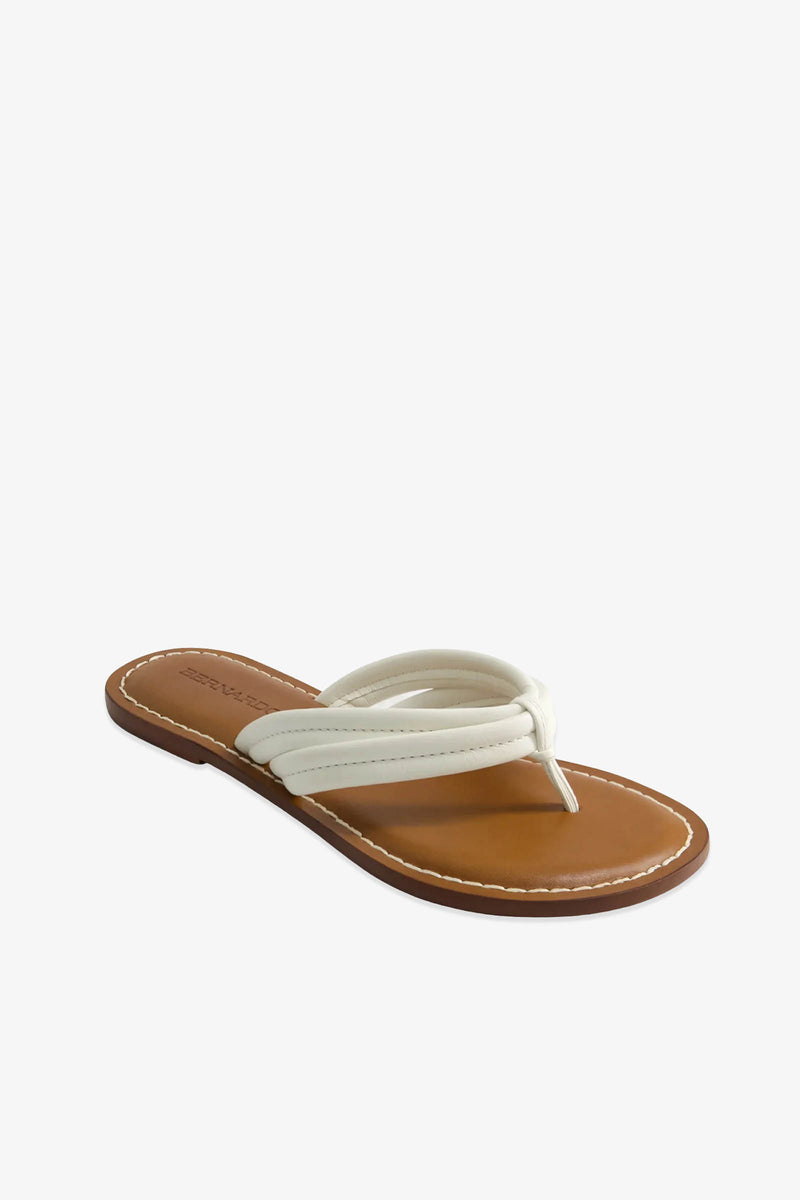 The Miami Sandal features a single tan flat design with white padded thong straps, a brown sole, and visible white stitching, displayed on a white background.