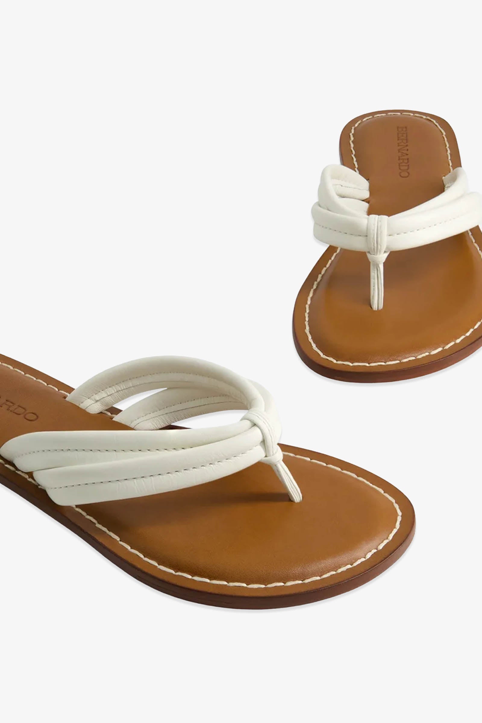 A pair of Miami Sandals featuring tan soles and padded white thong straps with visible stitching around the edges, displayed on a white background.
