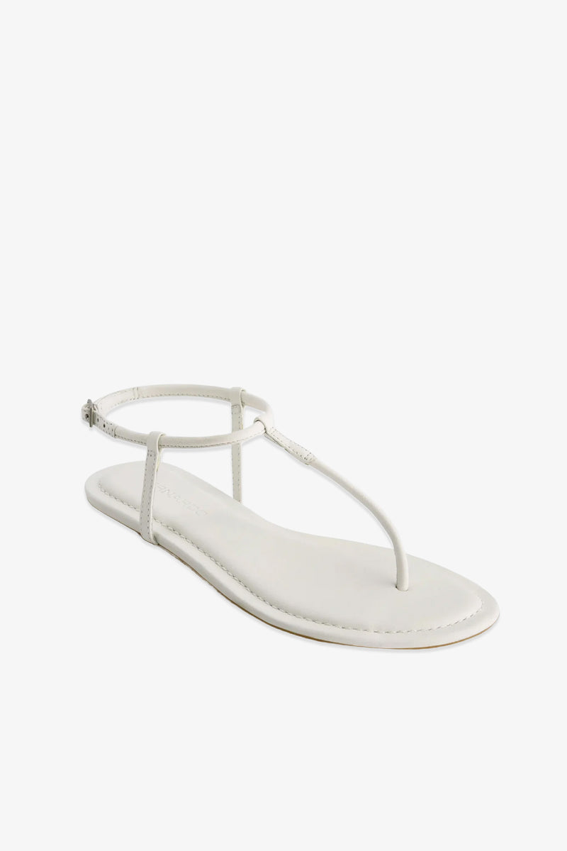 The Hercu Sandal is a single white flat sandal featuring a thin ankle strap, a minimalist thong design, and a simple sole, displayed against a white background.