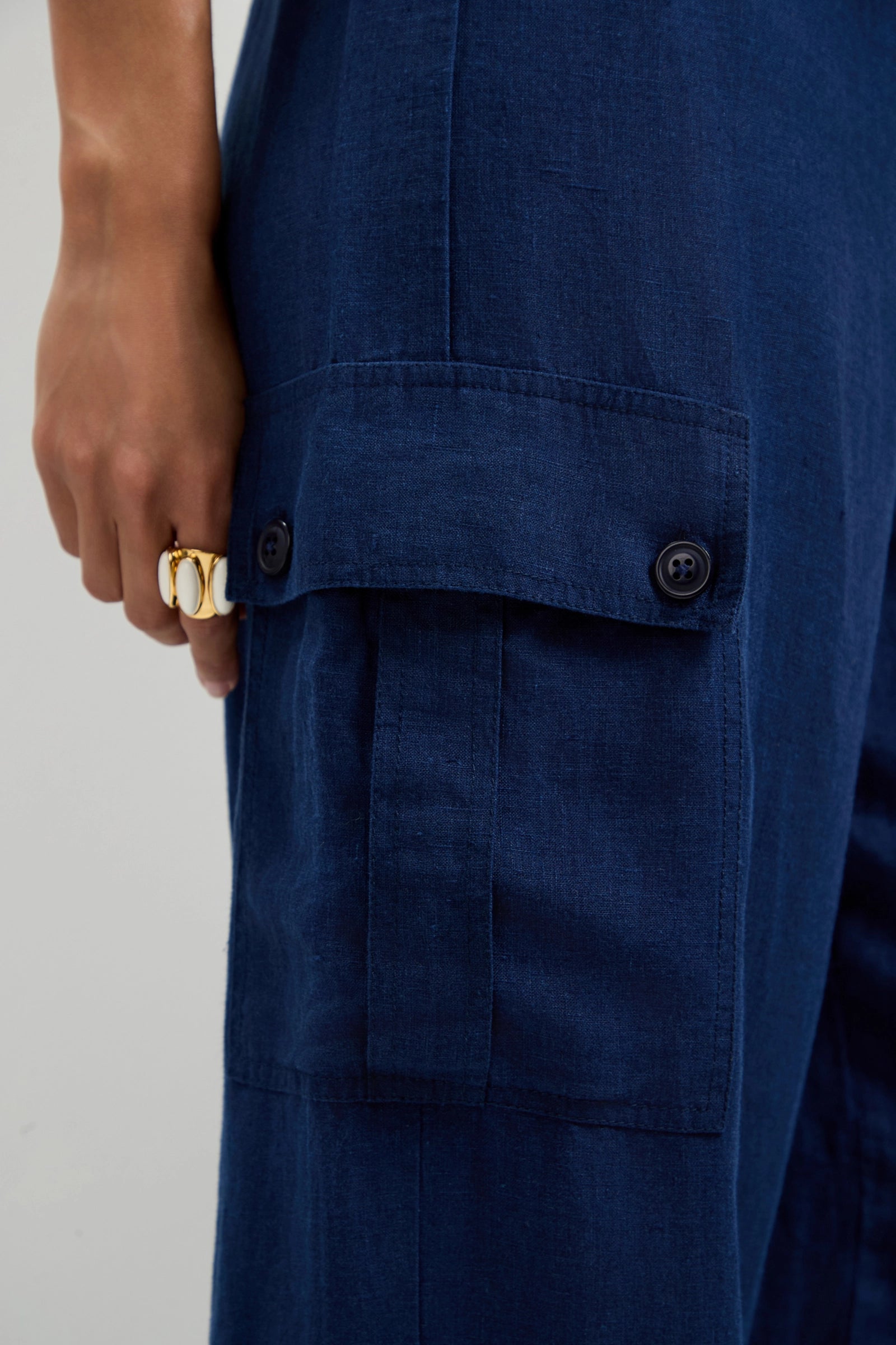 A close-up of a person's hand wearing Alico Cargo Pants.