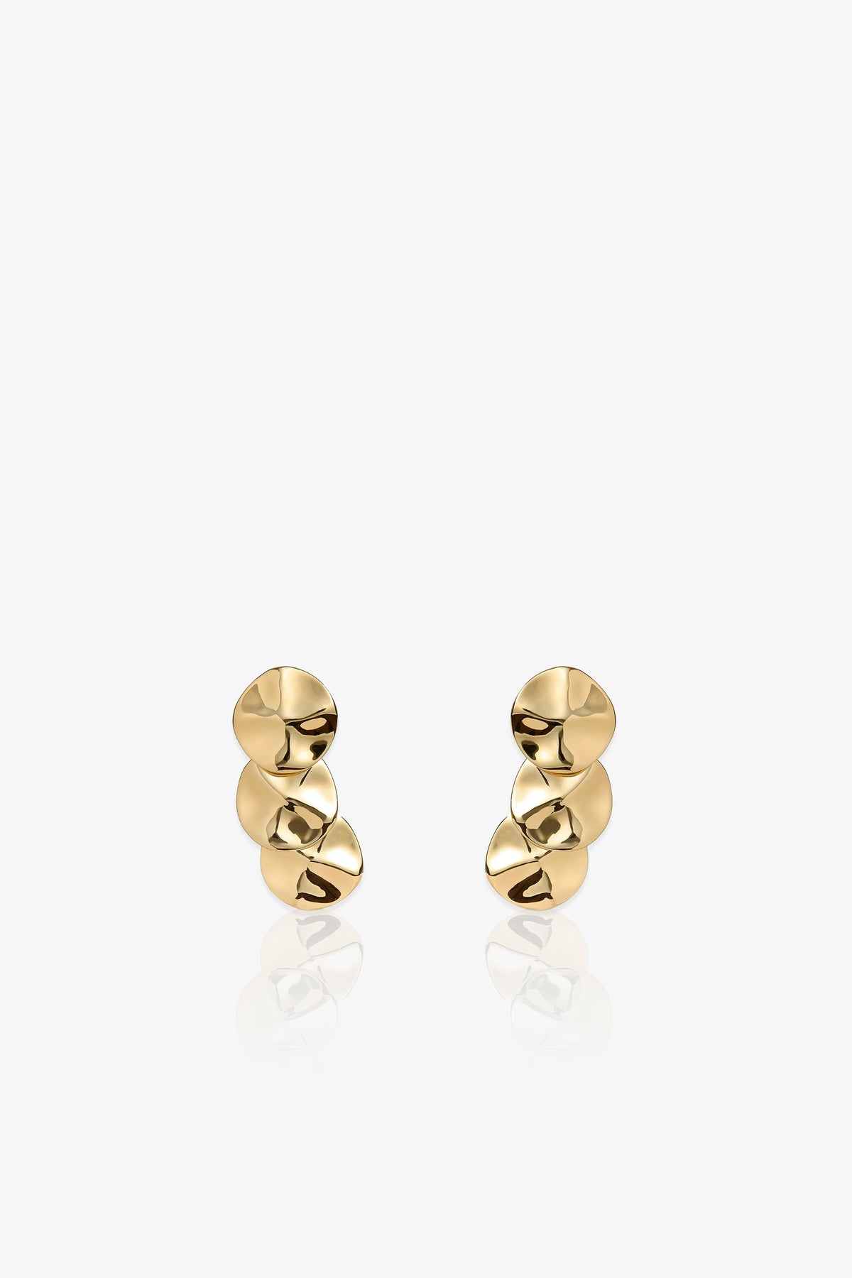 A pair of Socialite Statement Earrings, each featuring three irregular, disc-shaped gold pieces stacked vertically, displayed against a plain white background.