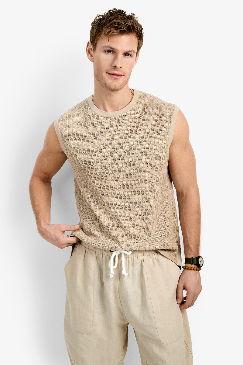 A man wearing the Tovey Mesh Tan stands against a plain white background, looking at the camera with a relaxed expression.