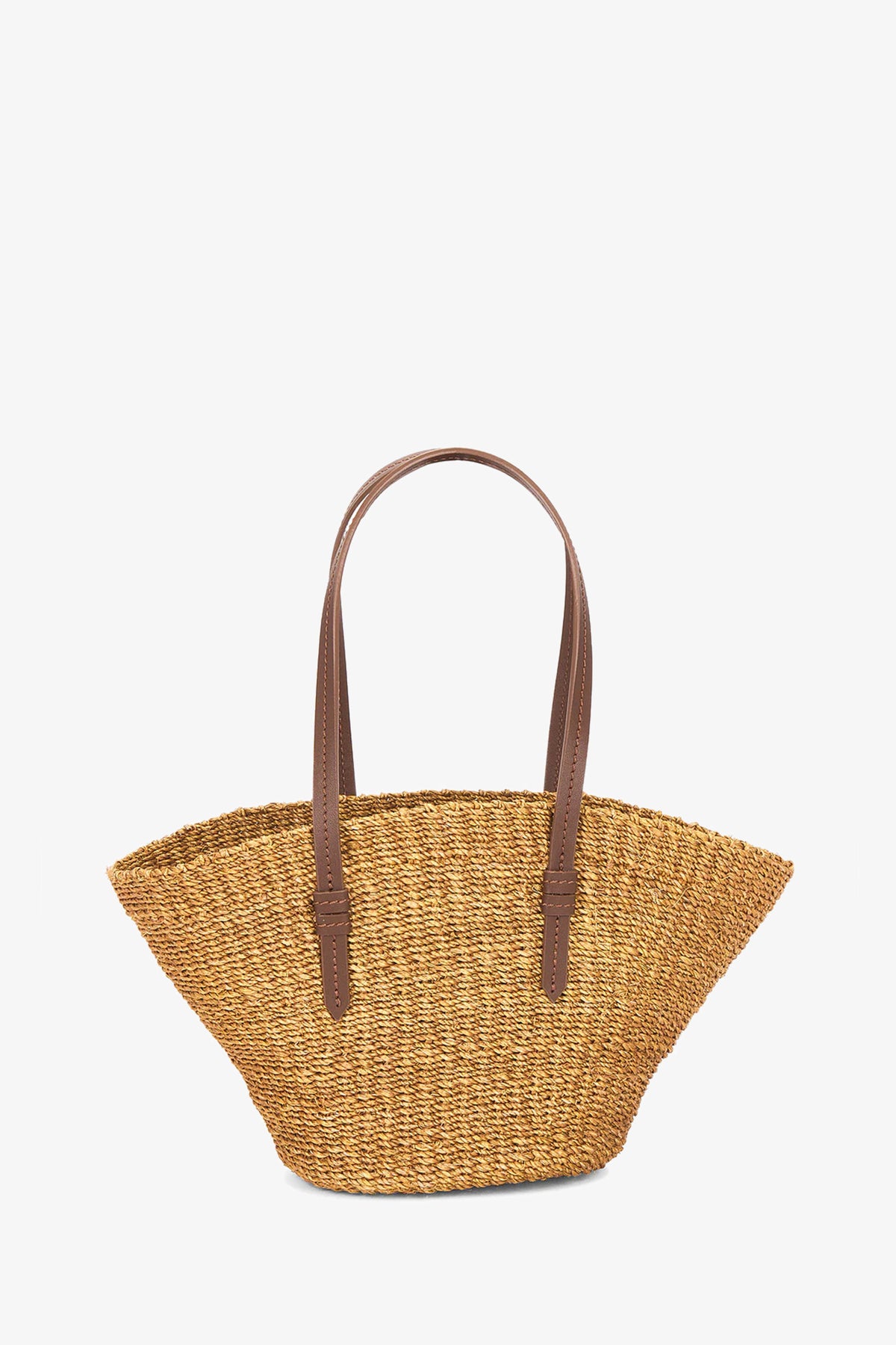 The East West Mini Tote, a woven straw bag with two long brown leather handles, is shown against a plain white background.