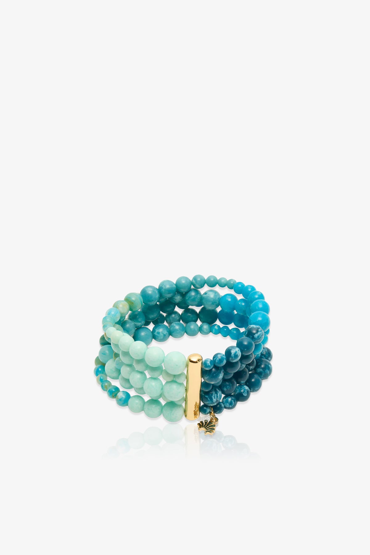 The Riviera Five Strand Bracelet features round beads in shades of blue and green across multiple strands, accented by a gold rectangular bar and a small gold charm, and is displayed on a white background.