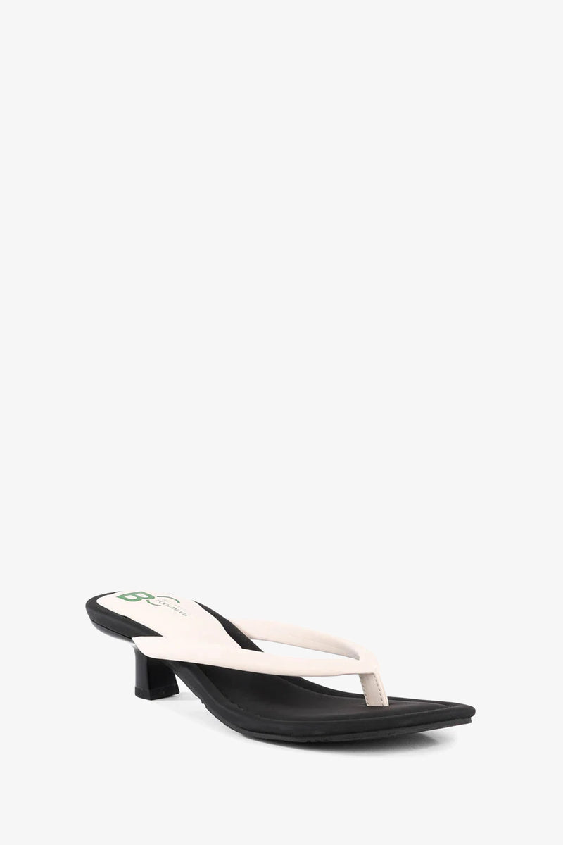 A single Riptide Sandal with a low black heel and white thong strap, displayed on a plain white background.
