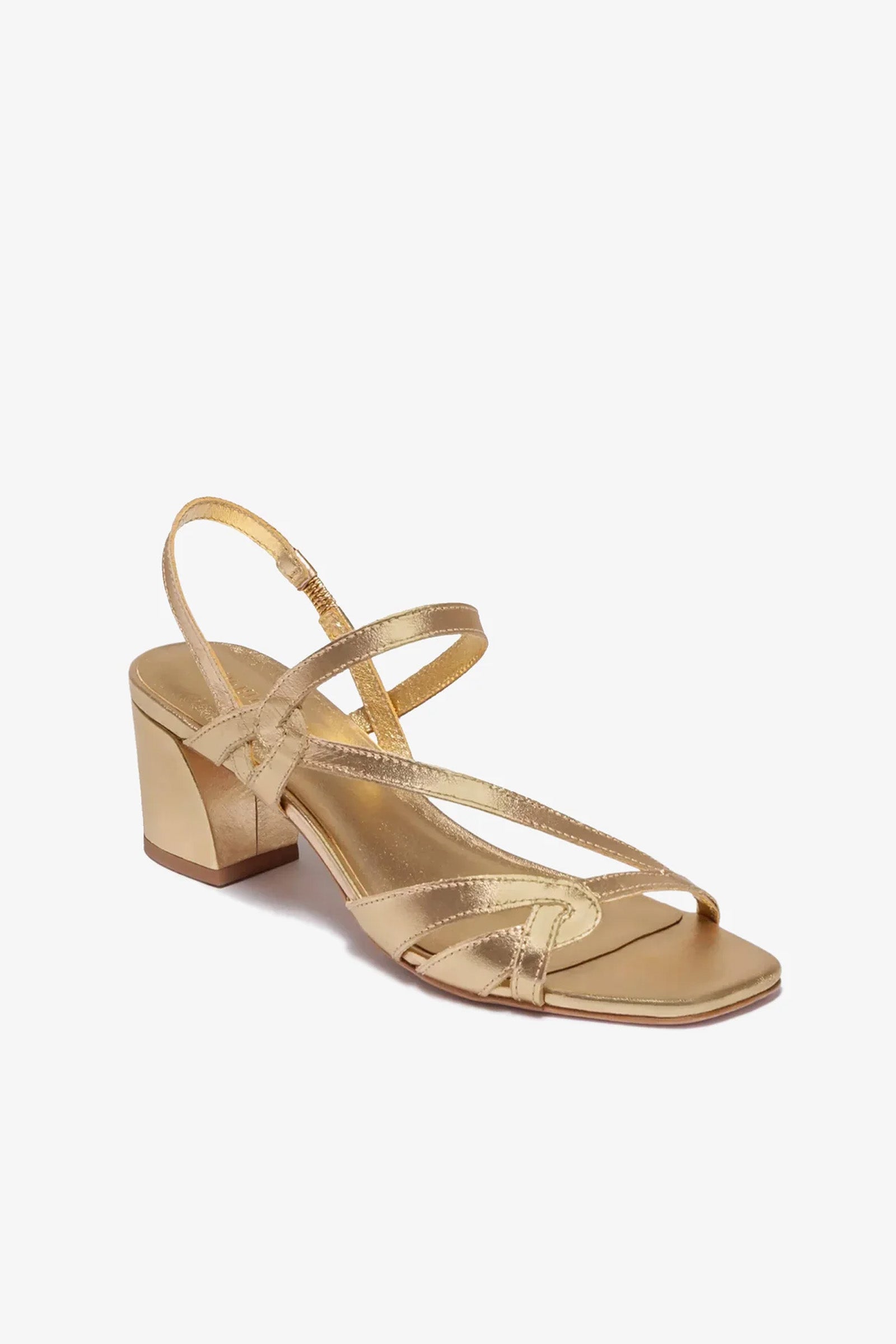 The Gyoda Heeled Sandal is a gold strappy sandal featuring a low block heel, open toe, and ankle strap, shown on a white background.