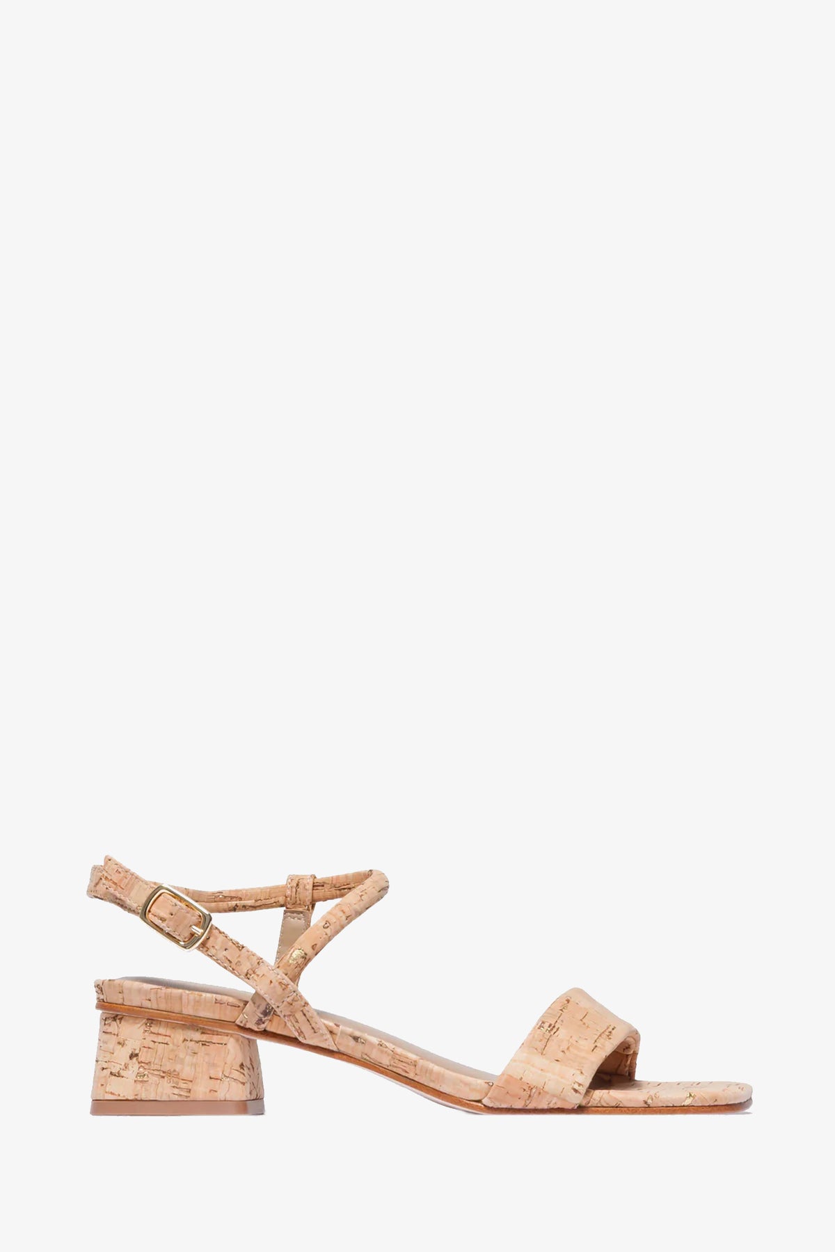 The Josei Low Heel Sandal is shown in profile on a white background; it features a cork sole, low block heel, open toe, and an ankle strap with a small buckle.