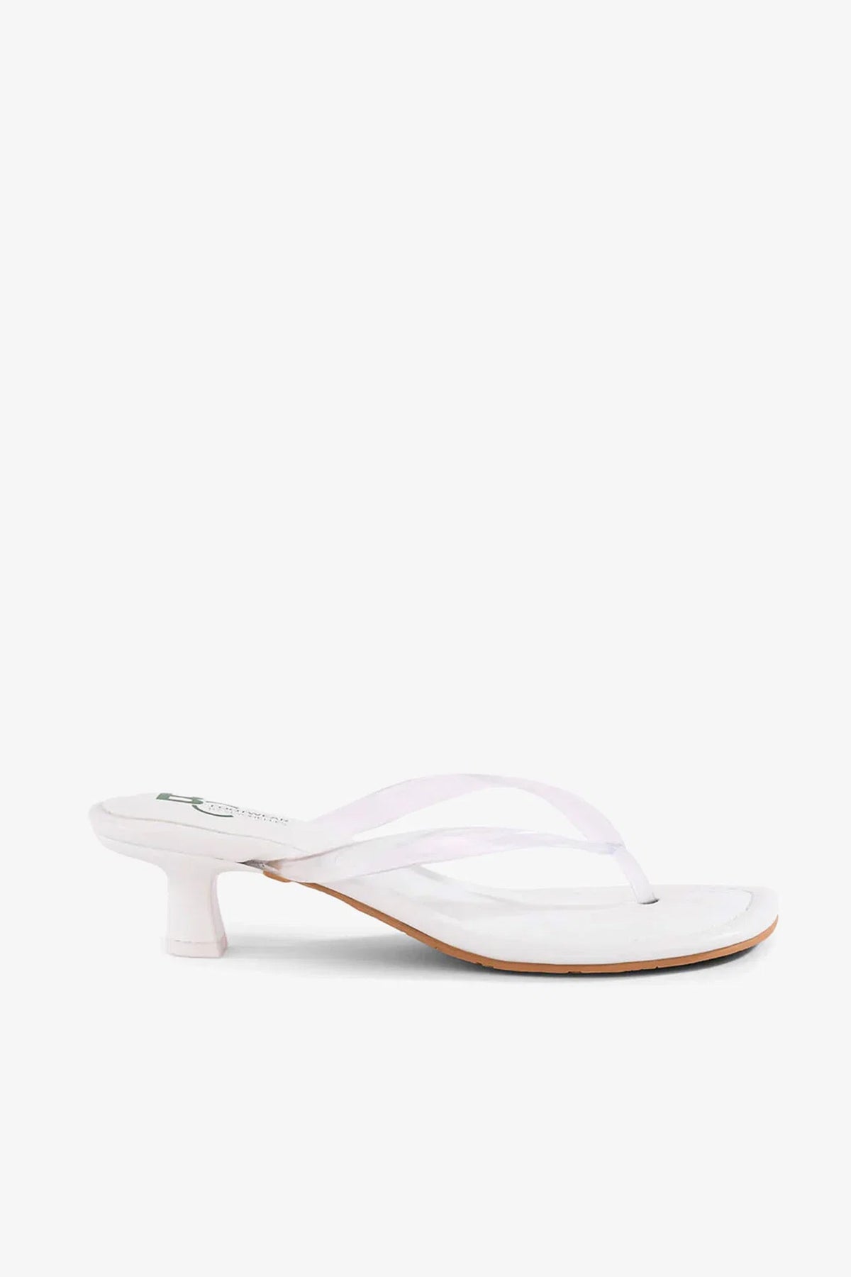 The Starbust Sandal, featuring a white thong strap design and a low, cylindrical heel, is displayed in a side view against a plain background.