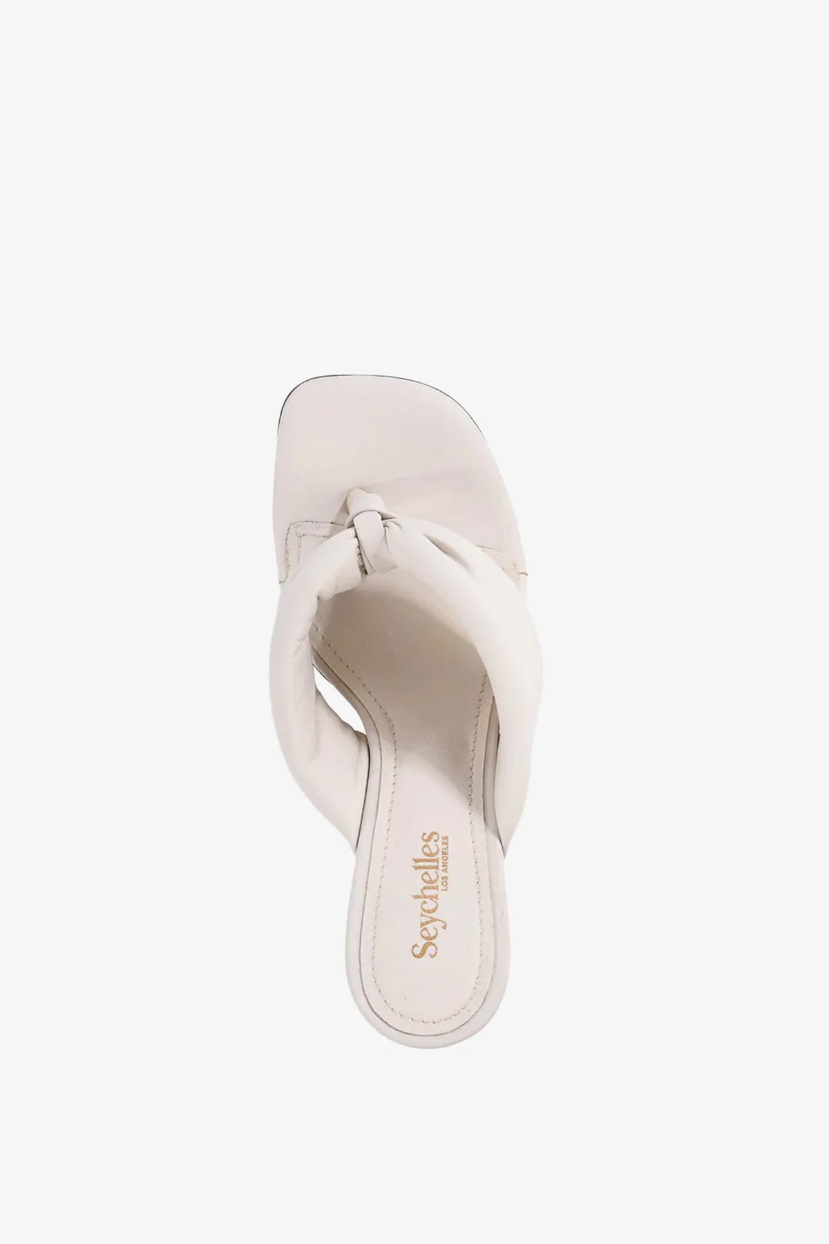 A single white Wishing Well Wedge sandal featuring a twisted strap design and a square toe, viewed from above. The insole displays Seychelles branding in gold lettering.