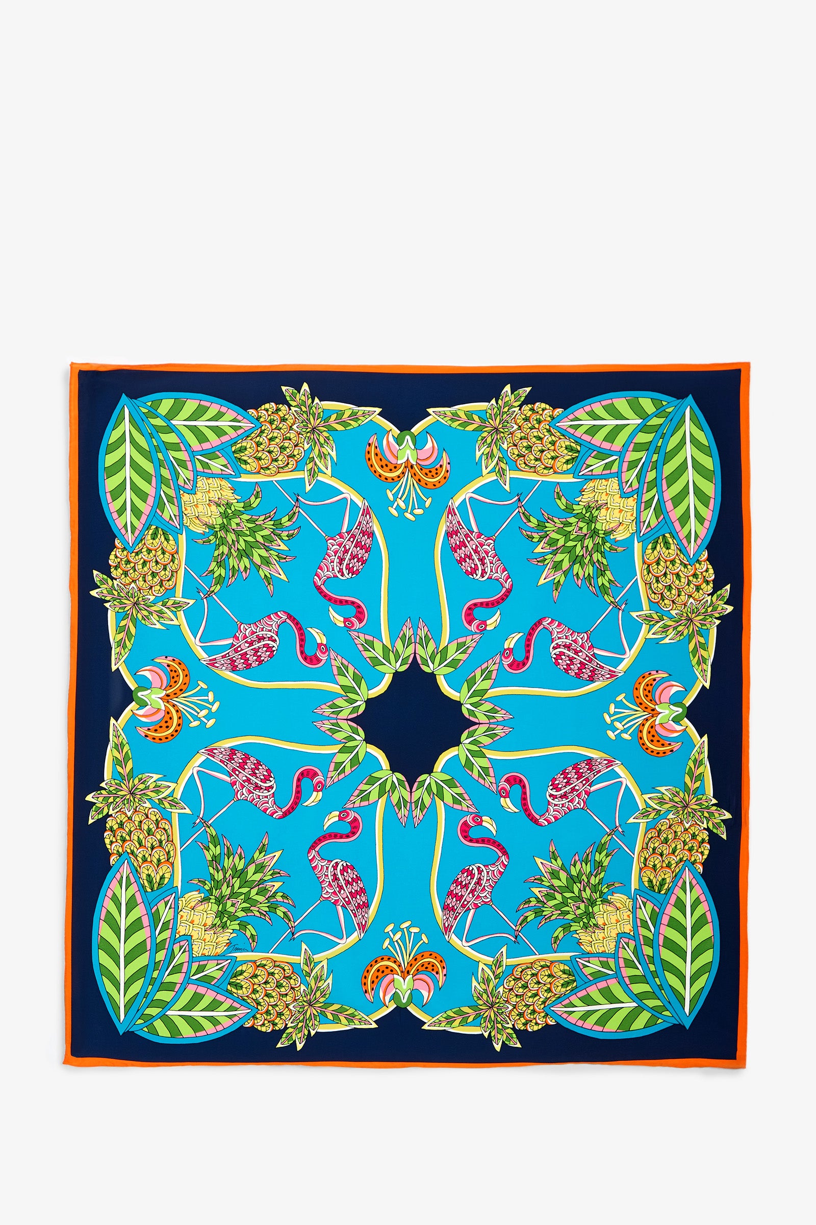 The Tiger Lily Scarf is a square scarf featuring a vibrant pattern of pink flamingos, green leaves, and pineapples on a blue background, finished with an orange border.
