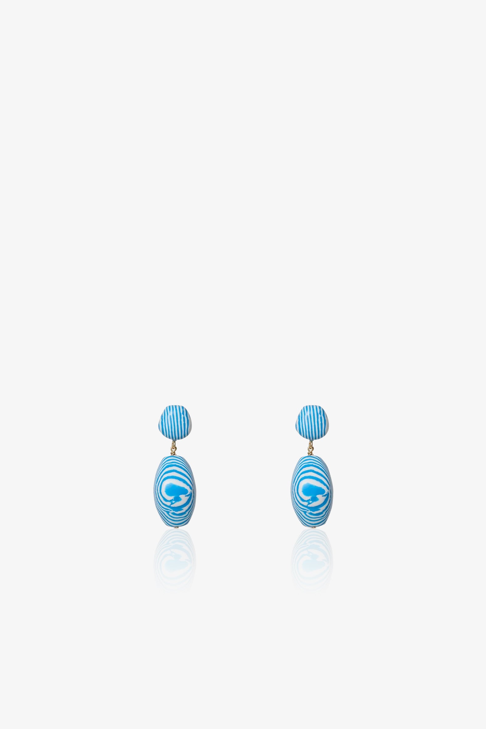 A pair of Ocean Baroque Double Drop Earrings featuring blue and white striped oval studs with larger swirled oval pendants, shown against a plain white background.