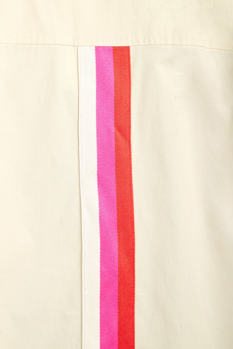 The OPPONENT DRESS features a cream-colored fabric with three closely spaced vertical stripes—white, pink, and red—running parallel along the seam.