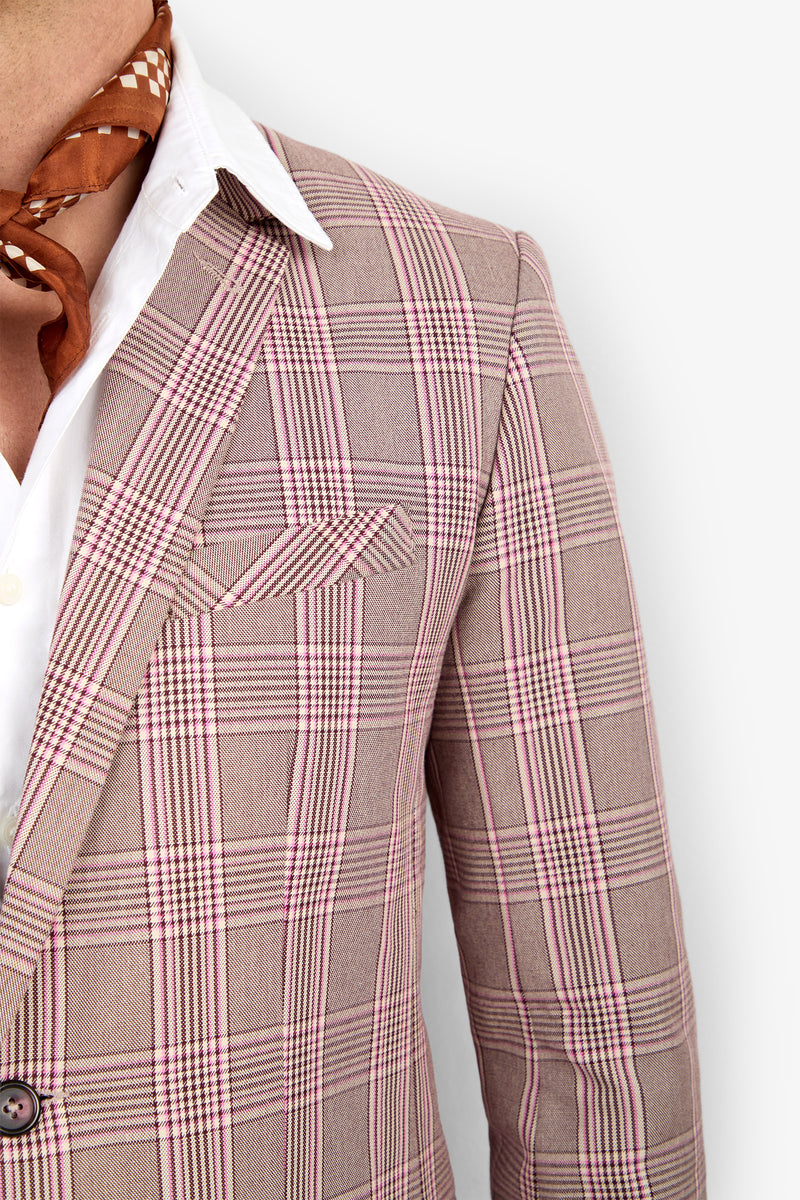 A person wearing the THURSTON BLAZER, a light plaid style over a white dress shirt with a brown patterned scarf at the neck, shown from shoulders to mid-torso against a white background.