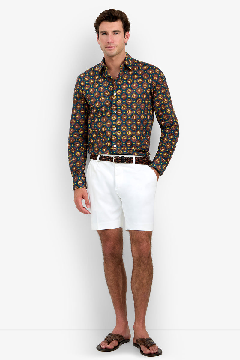 A man wearing the Aaron Shirt, white shorts, a brown belt, and brown sandals stands against a plain white background.