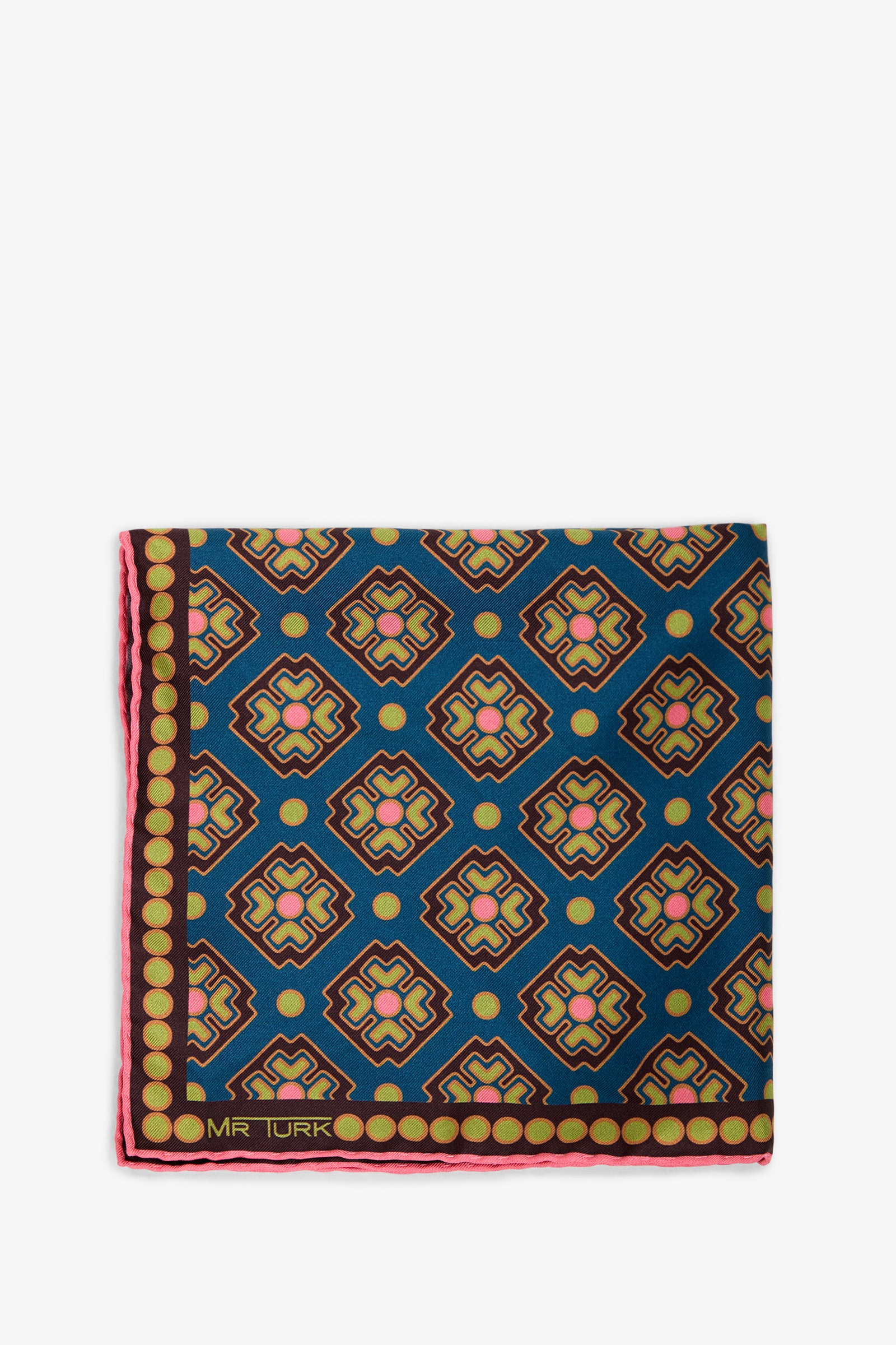 A folded Pocket Square featuring a geometric pattern in blue, pink, yellow, and black, accented by a border of yellow dots with “MR TURK” printed in the corner.