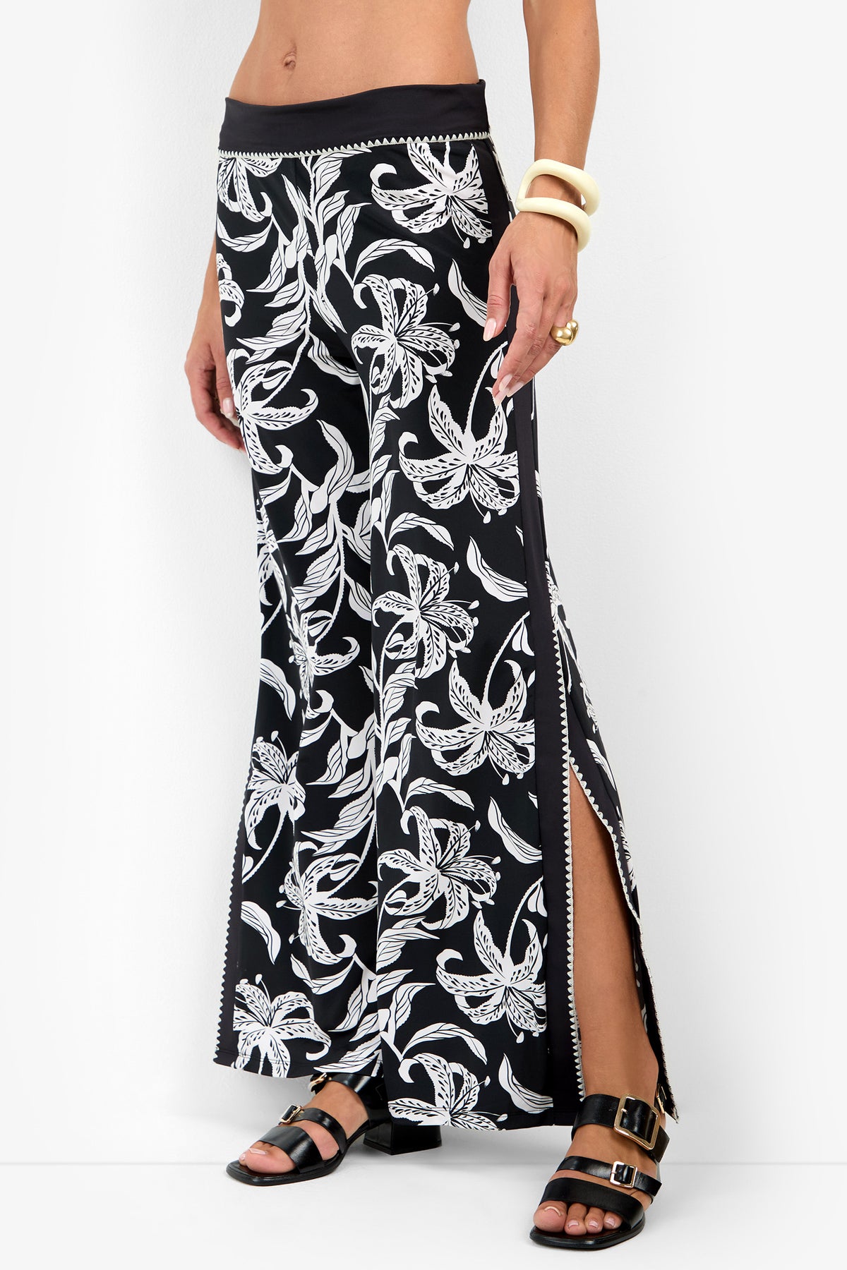 GOLDEN HOUR BLOOM SWIM PANT in a black and white floral print, featuring a solid black waistband and side slits.