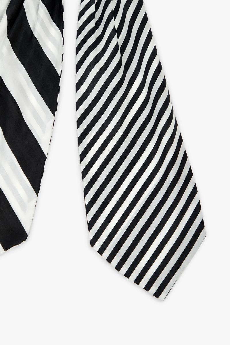 Two Savoir Stripe Silk Ascots with diagonal stripes: the left ascot features wide black and white stripes, while the right ascot displays narrower black, gray, and white stripes. Both ascots are set against a plain white background.