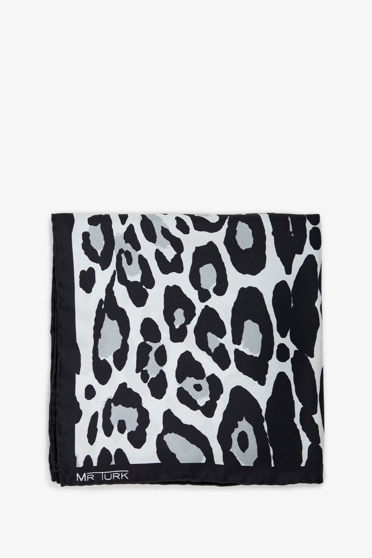 A folded Snow Leopard Pocket Square featuring a black and white leopard print and MR TURK in white text on one corner.