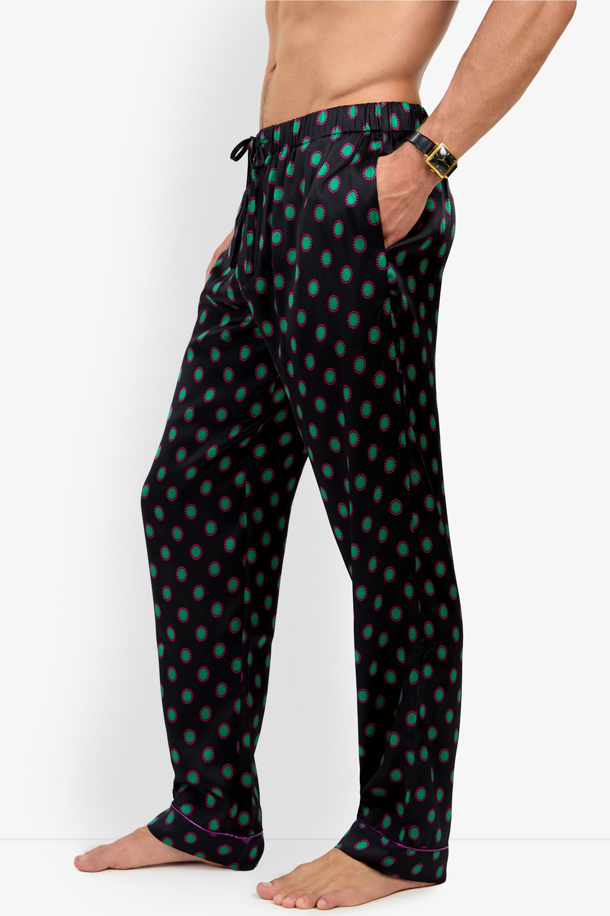 PJ PANT in black 100% silk, featuring a repeating pattern of green circles with red borders, a drawstring waistband, and a pocket.