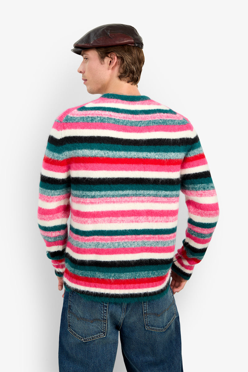 A person seen from behind, wearing a MR. BARDINI fuzzy, multi-colored striped wool sweater and a dark cap.