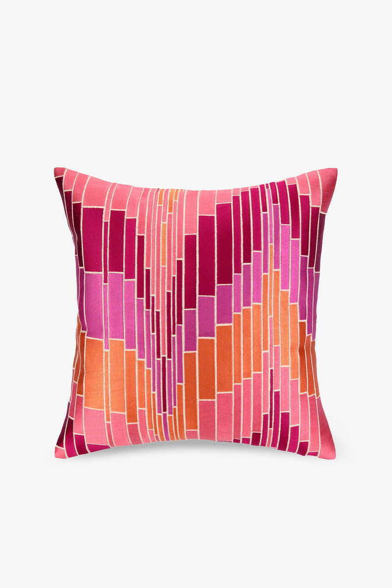 The Loomis Embroidered Square Pillow in PINK features a geometric pattern with rectangular shapes in pink, orange, and red on a white background.