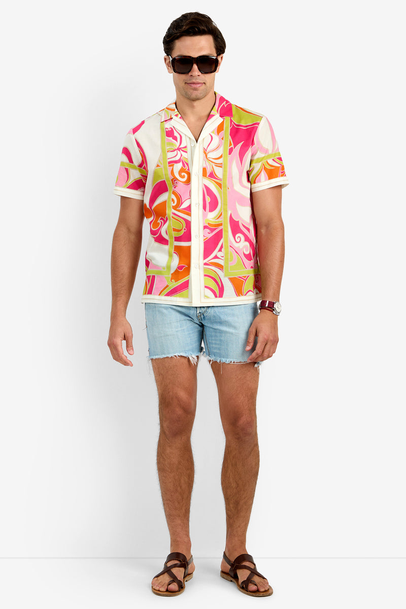 A man in the JOSUE CAMP SHIRT (MULTI), light blue denim shorts, brown sandals, sunglasses, and a wristwatch stands against a plain white background.