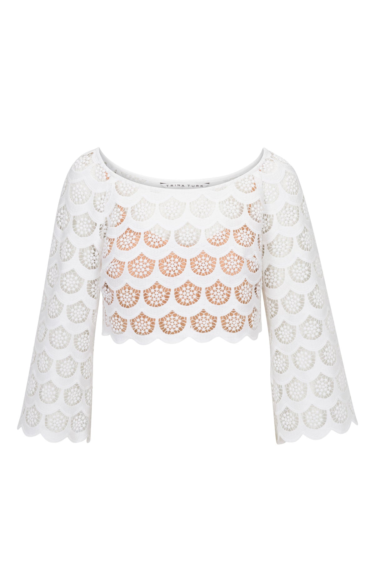 The Helen Crochet 3/4-Sleeve Crop Top features white, crocheted lace with a scalloped hem, circular cutouts over a light tan lining, and a wide boat neckline.