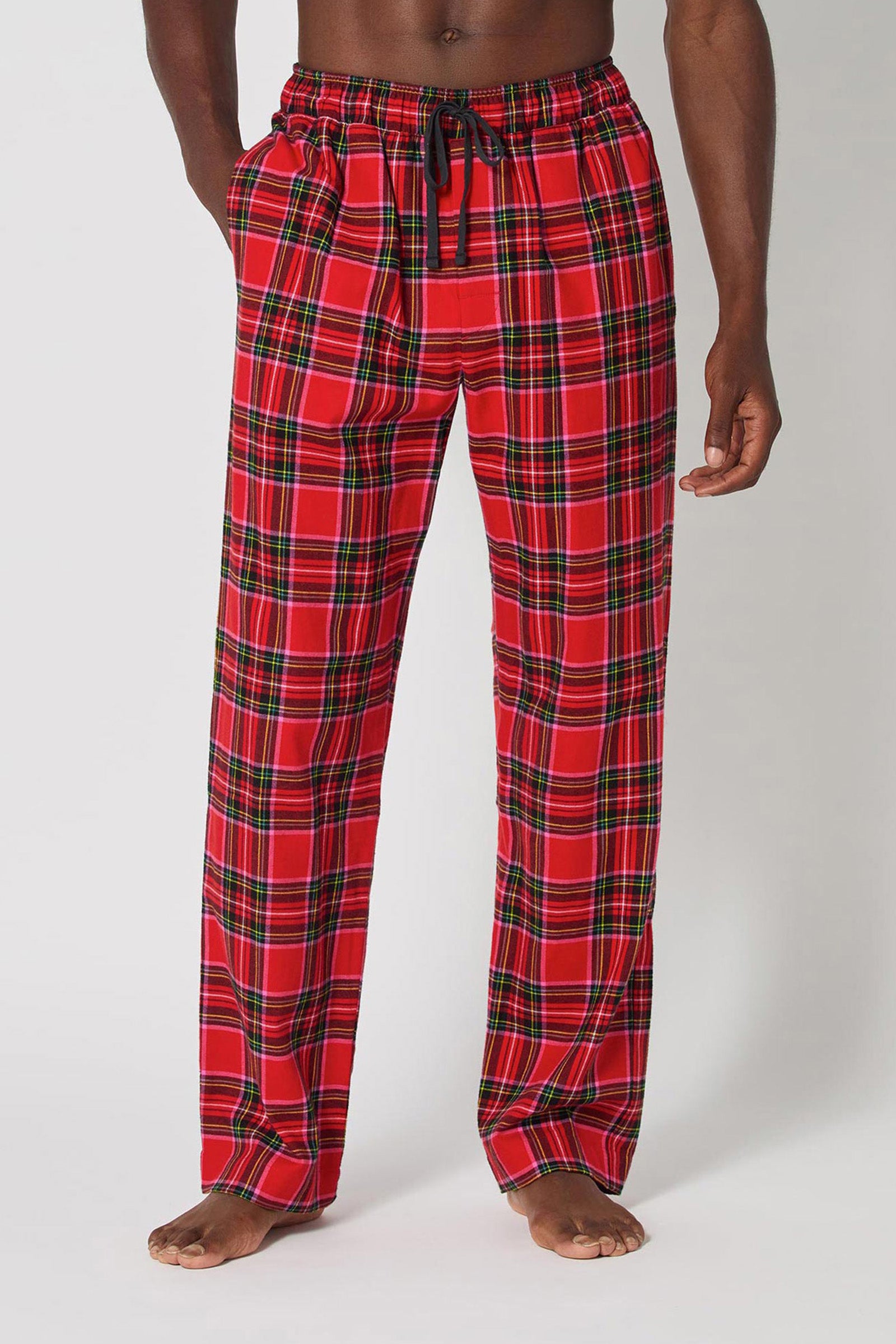 A person, mostly out of frame, stands barefoot against a plain white background wearing Christmas Plaid Men Pj Pant with a black drawstring.