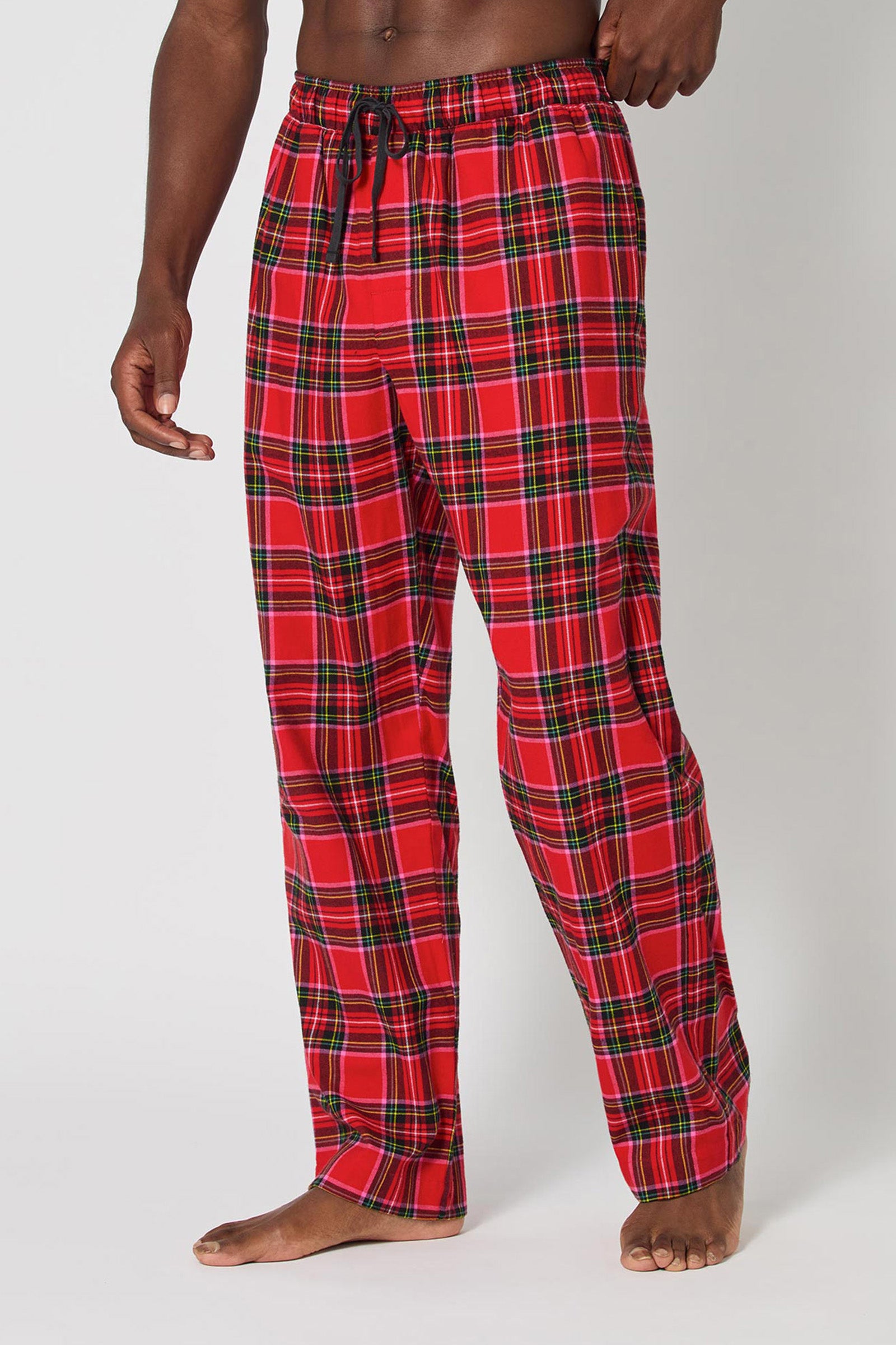 A person stands barefoot in Christmas Plaid Men Pj Pant with a black drawstring, against a plain white background.