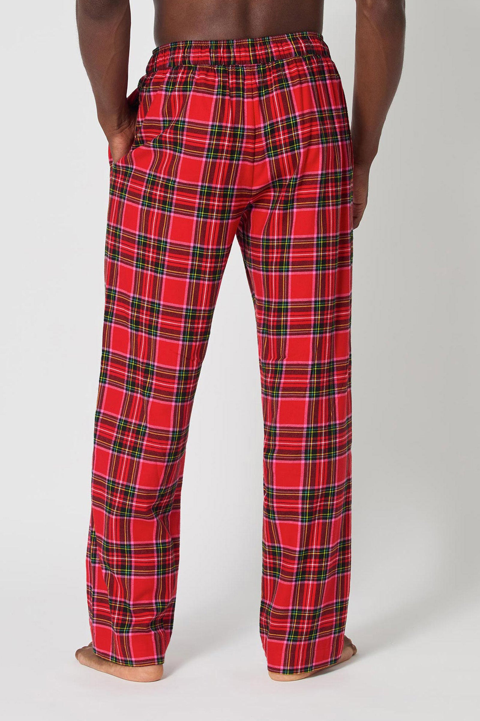A person stands barefoot facing away, wearing Christmas Plaid Men Pj Pant with an elastic waistband and pockets, against a plain light background.