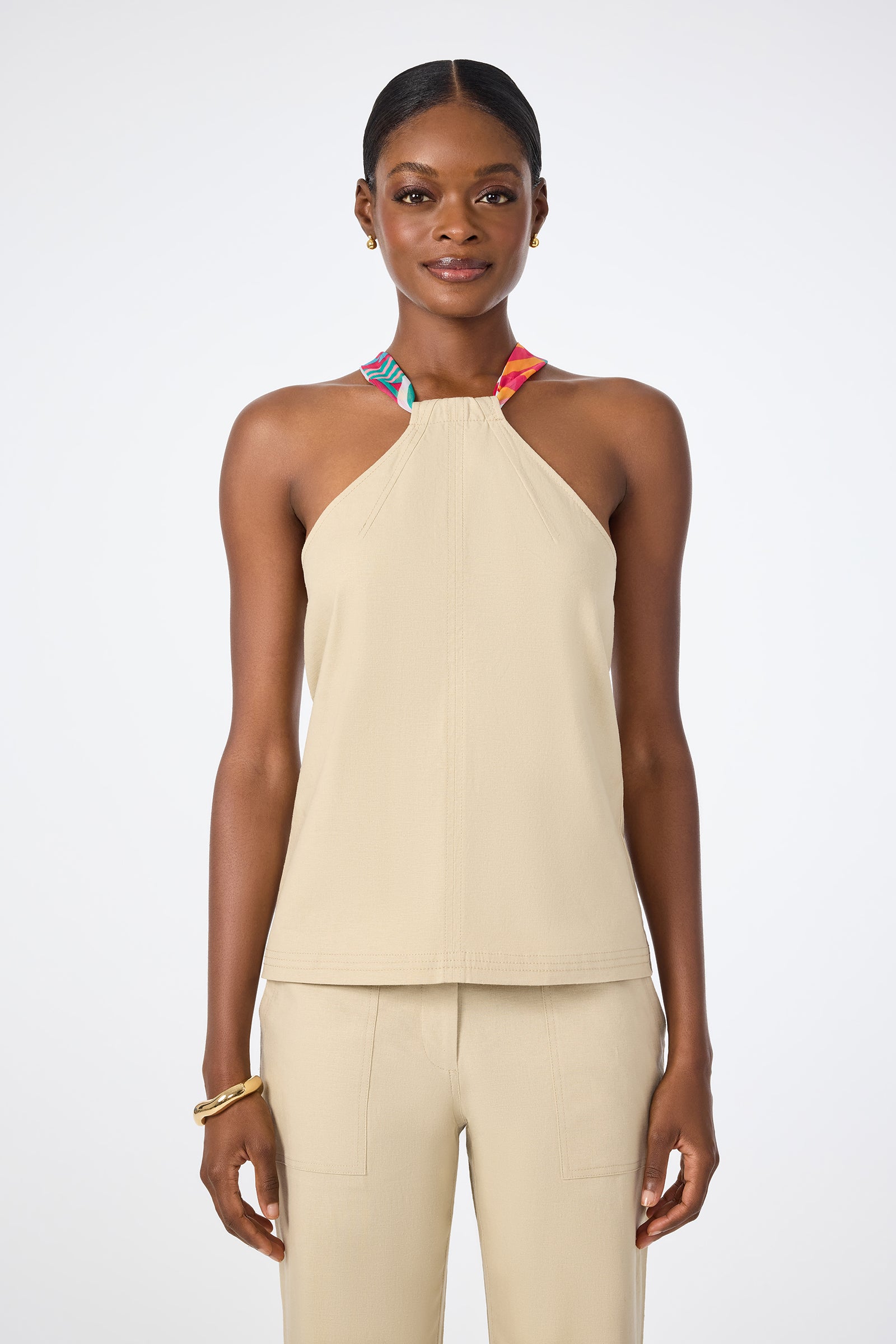 A woman wearing the Chatone Scarf Tie Halter Top and pants.