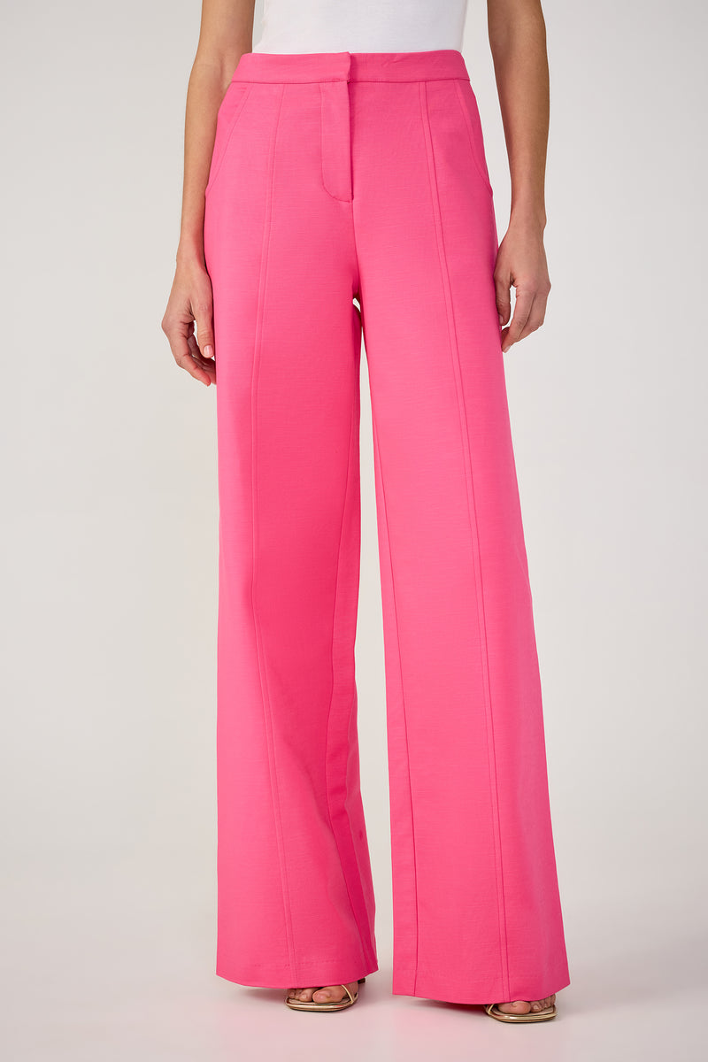 A person wearing the Half Court Wide-Leg Pant in Love All Pink with a white top and open-toed shoes, standing against a plain light background.