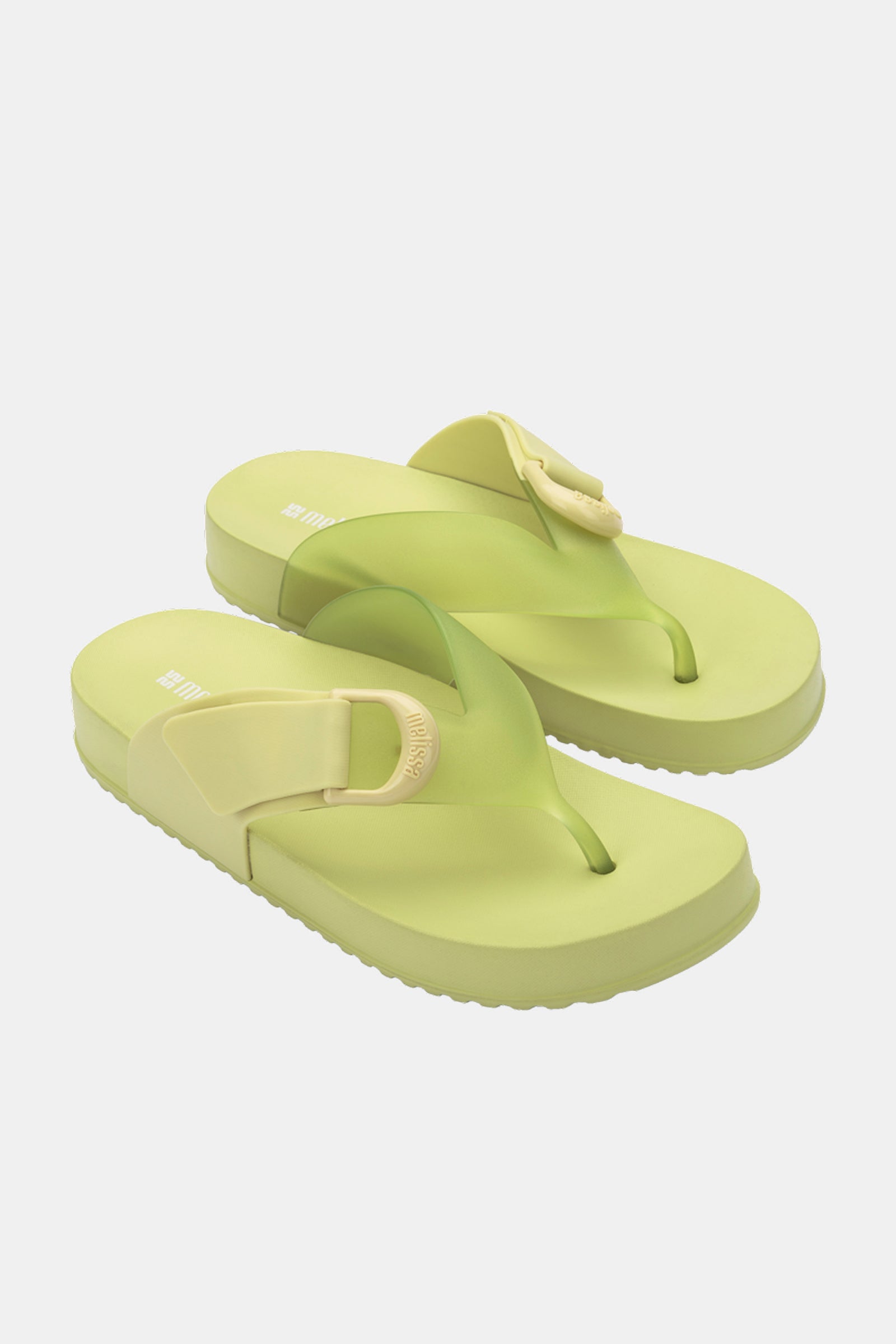 The Melissa Cozy Thong sandals in light green and yellow feature adjustable straps and are displayed on a white background.