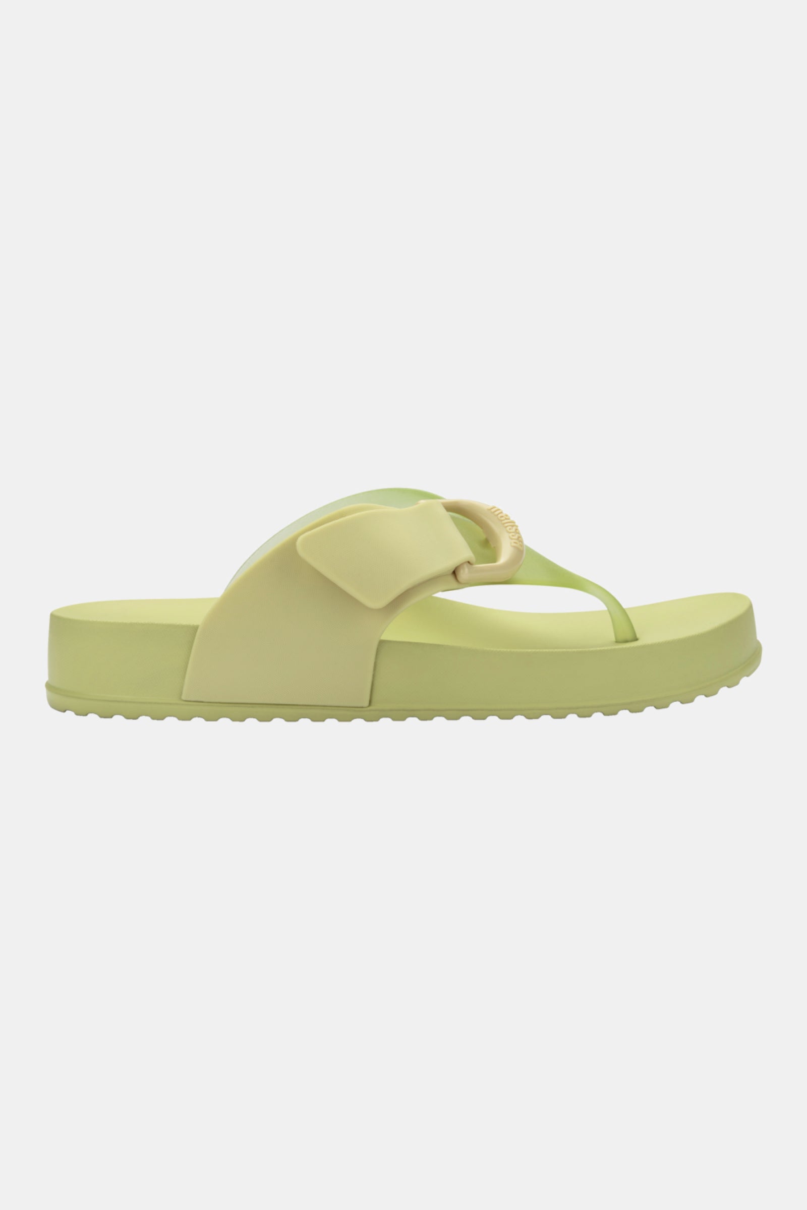Side view of the Melissa Cozy Thong flip-flop sandal in light green and pale yellow, featuring a thick sole and decorative strap detail, shown on a plain white background.