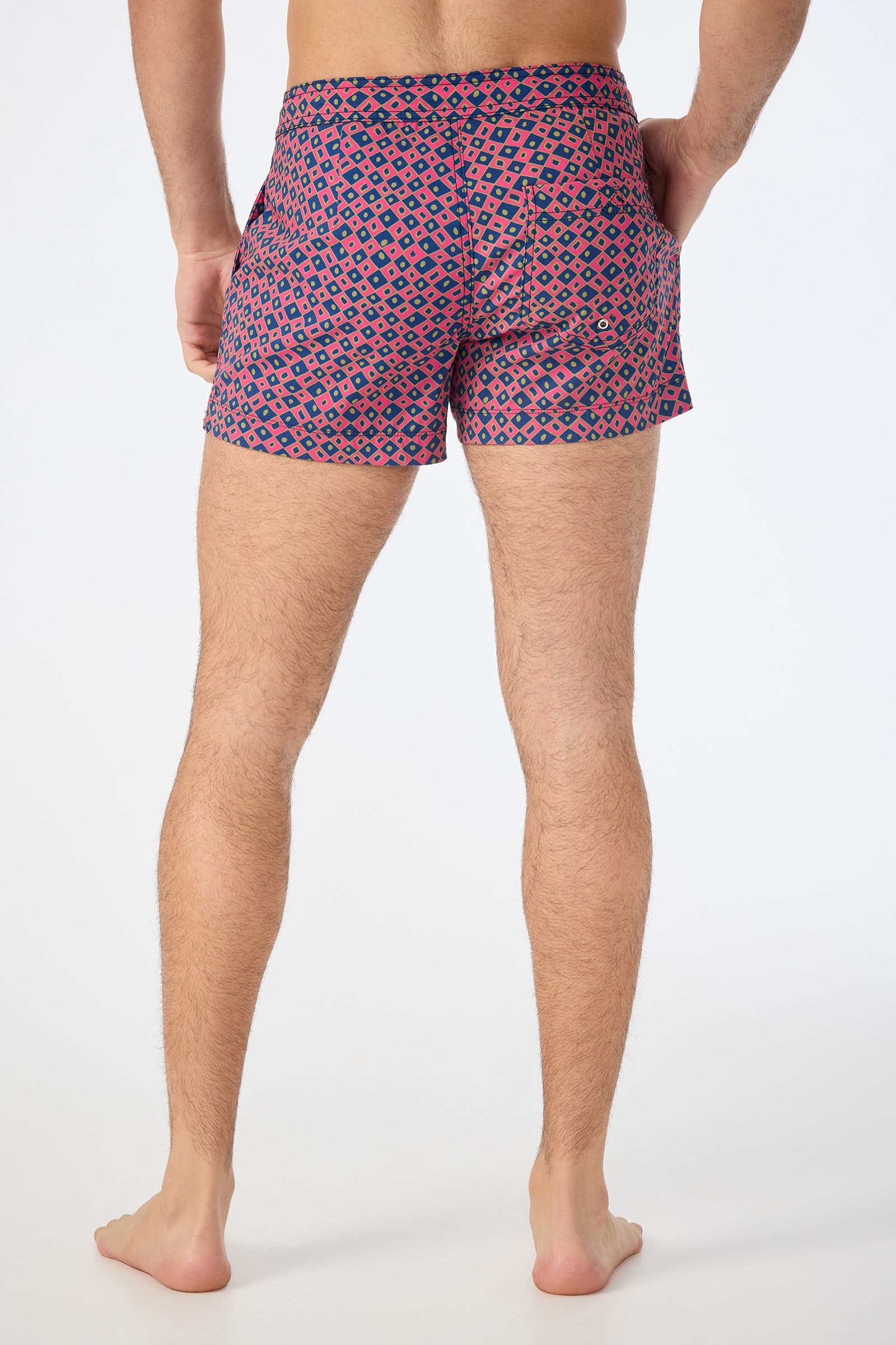 A man wearing the Chico Swim Trunk - Himari Herringbone with his hands in his pockets.