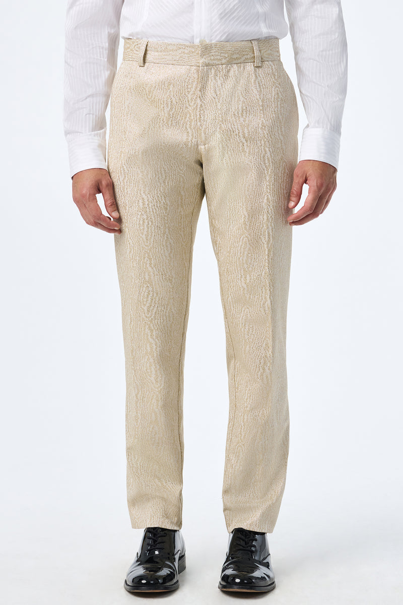 A person wearing Clyde Slim Trouser in light beige, a white dress shirt, and black shiny dress shoes stands against a plain white background.