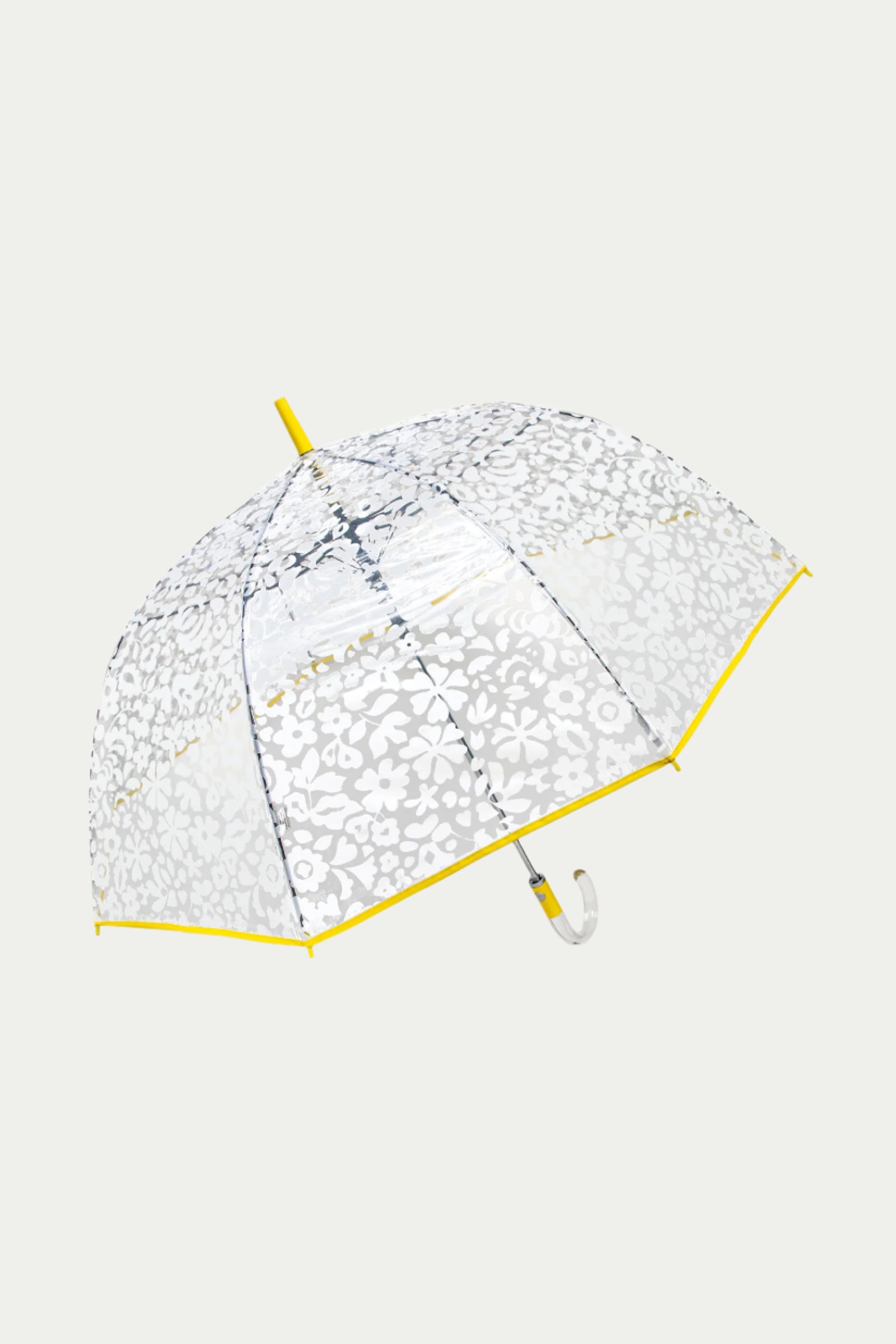 The TT X SR Clear Bubble Umbrella - Poolside features a clear canopy with a white floral pattern, yellow edge trim, and a curved white handle, shown against a plain light background.