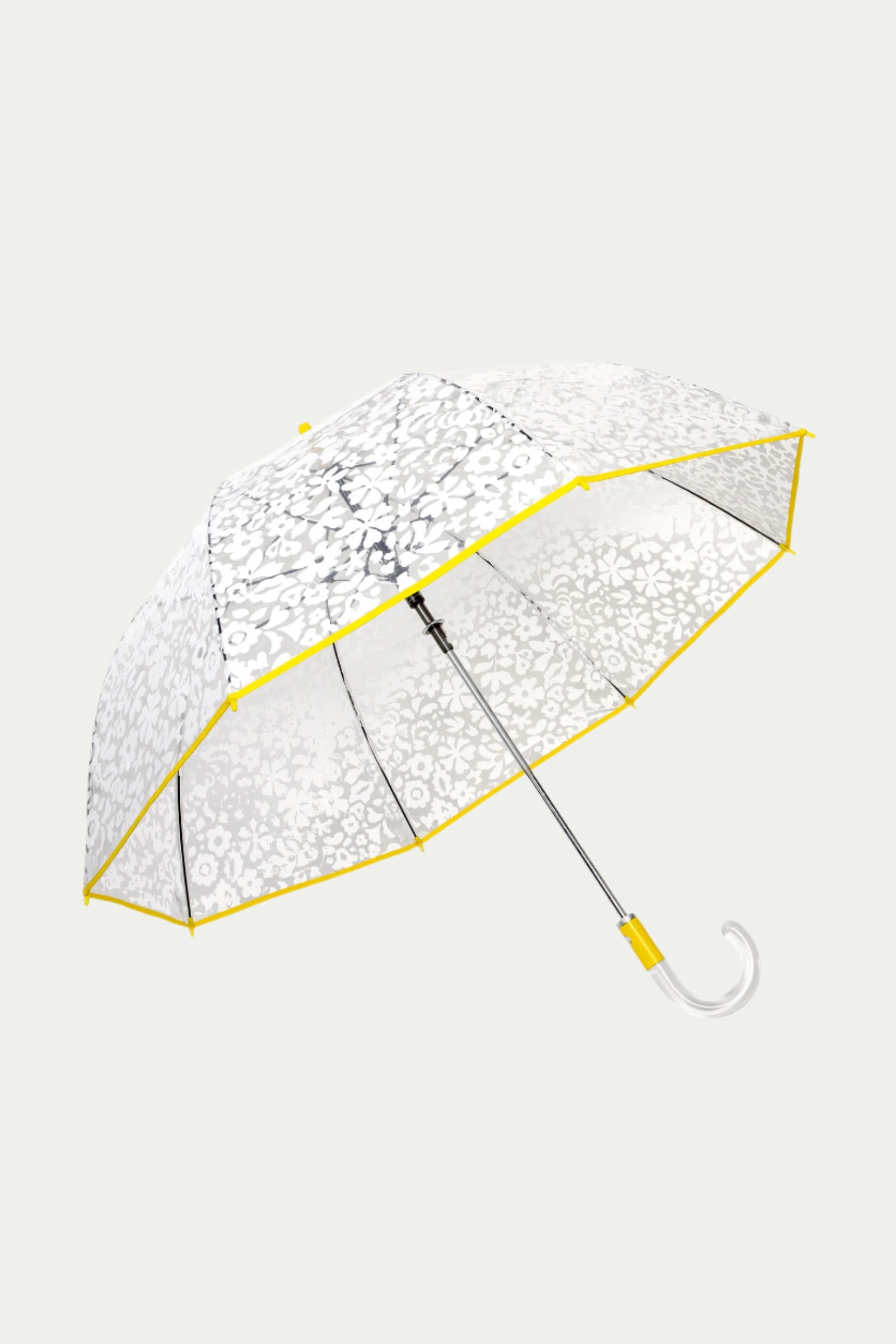 The TT X SR Clear Bubble Umbrella - Poolside features a transparent canopy with a white floral pattern, yellow-trimmed edges, a metal shaft, and a clear curved handle, shown against a light gray background.