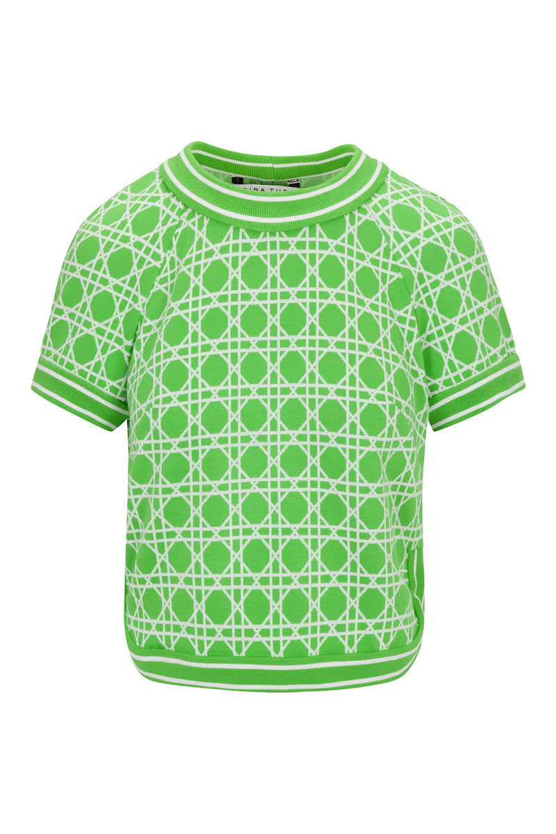 The Simona Short-Sleeve Crop Top - Billie Jean features a green knit design with a white geometric lattice pattern and ribbed green and white trim on the collar, cuffs, and hem.