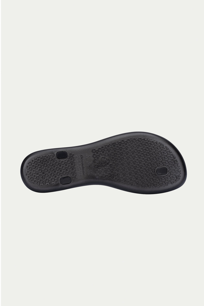The Ipanema Class Connect Sandal - Black features a rubber sole shown from the bottom, with a textured pattern and three circular plugs, set against a plain white background.