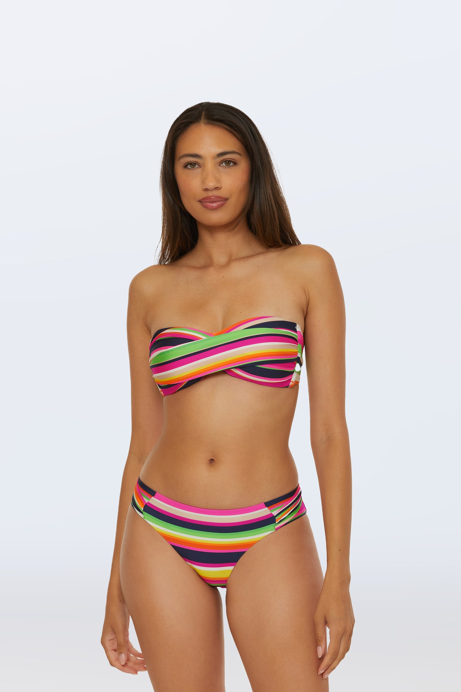 A woman wearing the Twist Bandeau Swim Top in Splash Stripe (Multi) stands against a plain light background.