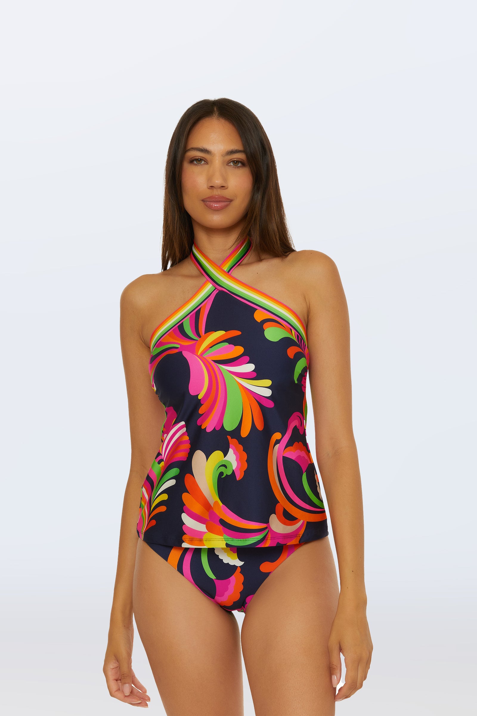 A woman models the Reversible Tankini Swim Top in Splash Stripe, standing against a plain light background, facing forward with a neutral expression.